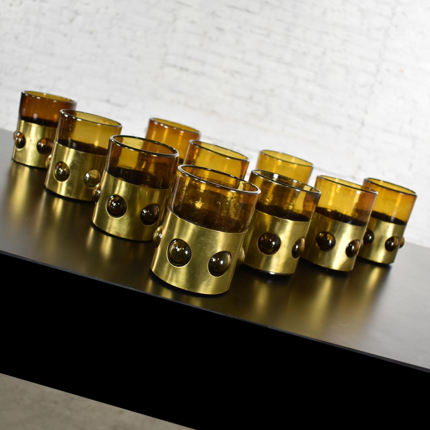 Incredible set of 10 imprisoned glass Brutalist modern Mexican glass tumblers in amber recycled bottle glass caged by brass bands. Designed and made by Filipe Derflingher (sometimes spelled Derflinger) at the Feders workshop. They are in original