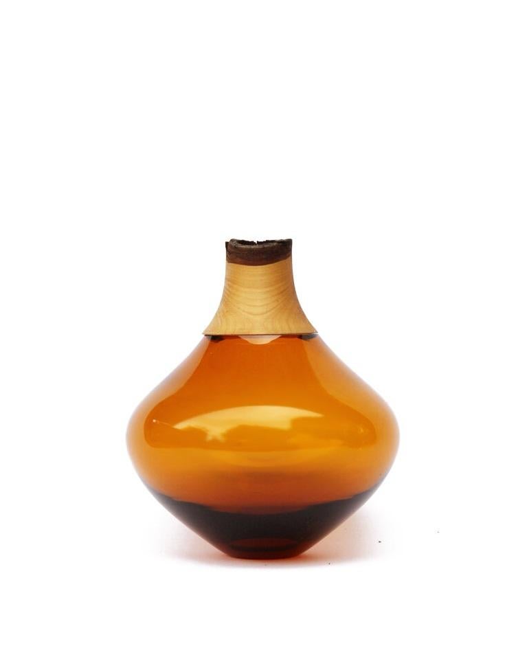 Amber Matisse stacking vessel II, Pia Wüstenberg
Dimensions: D 12 x H 16
Materials: glass, wood

The Matisse Stacking Vessels are treasures, small splashes of curvy glass with a wooden crown. The collection was originally designed for the Tate
