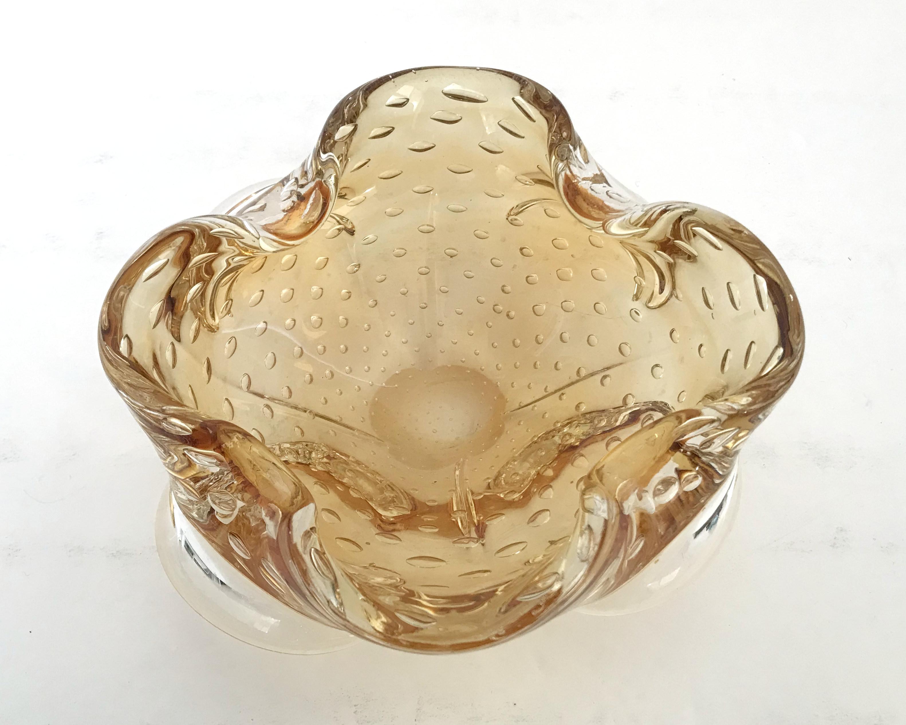Vintage Italian amber Murano glass ashtray or bowl carefully hand blown with small bubbles inside the glass using pulegoso technique / Made in Italy, circa 1960s
Measures: diameter 7 inches, height 2.75 inches
1 in stock in Palm Springs ON 50% OFF
