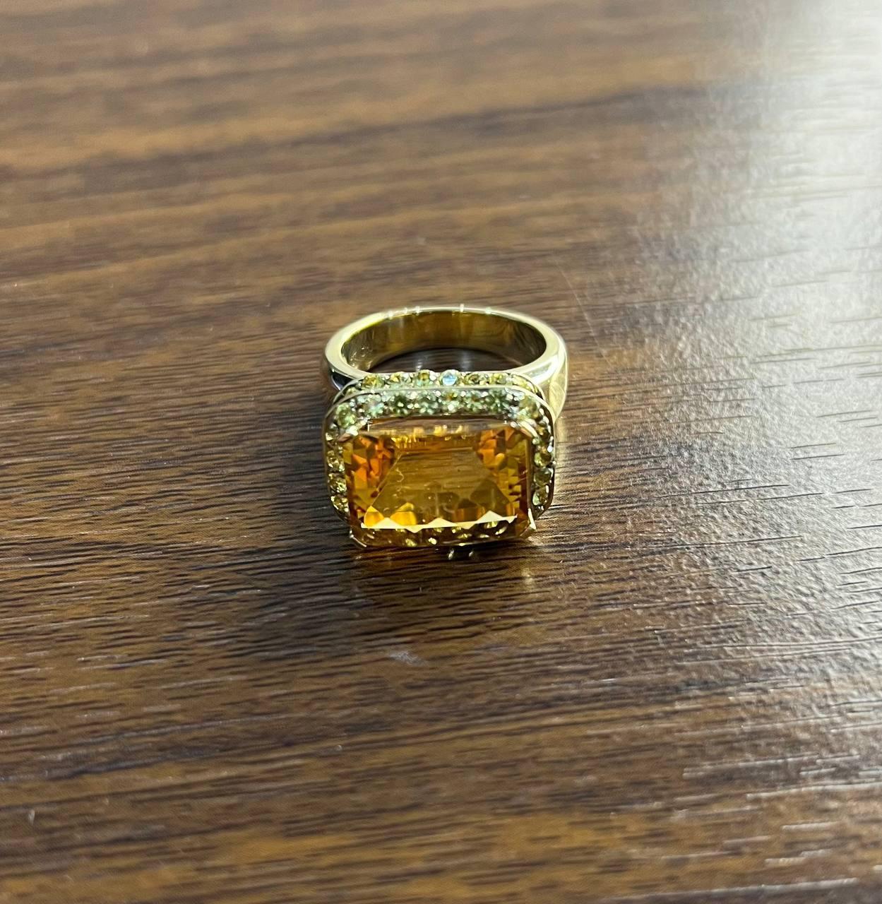 Experience the allure of elegance with our Citrine Ring, a captivating piece that showcases exquisite craftsmanship.
This remarkable ring features a large, rectangular citrine , its facets catching the light with every movement. The stone is set in