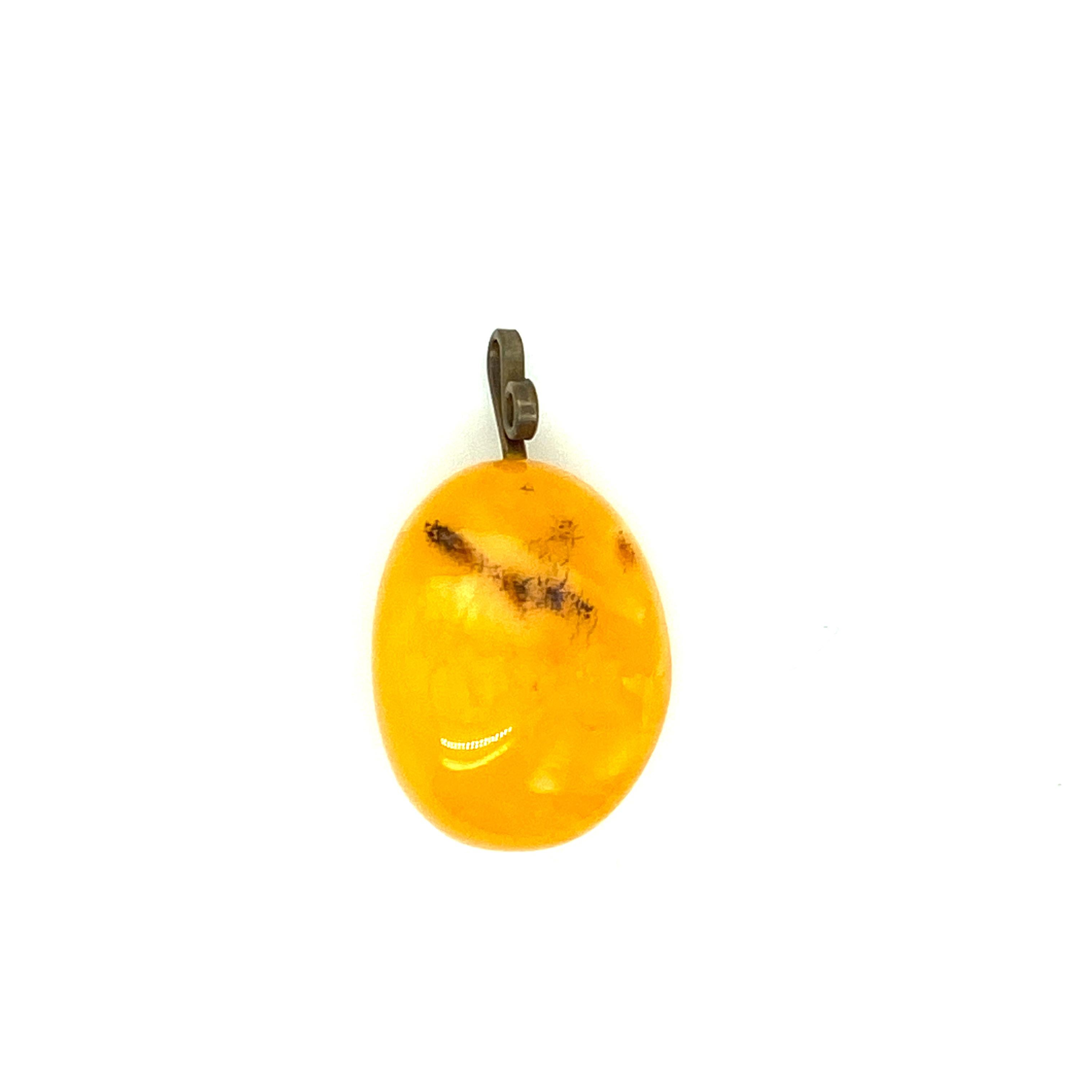 One amber pendant measuring 20x15mm.  Circa 1970s.