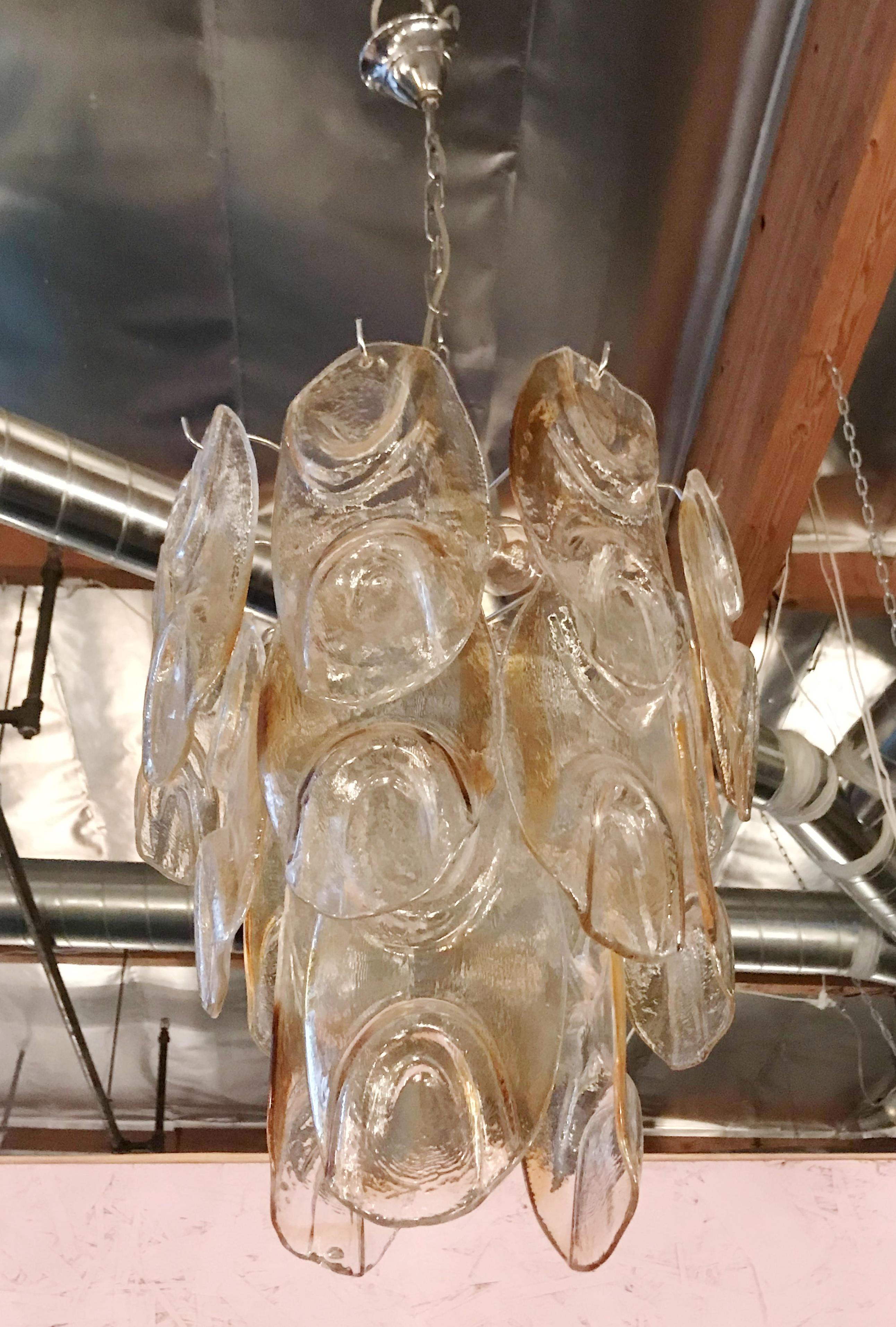 Vintage chandelier with clear and amber Murano glass leaf petals hanging on nickel frame / Designed by Mazzega / Made in Italy, circa 1960s
3 lights / E12 or E14 type / max 40W each
Measures: Diameter 15 inches, height 19 inches plus chain and