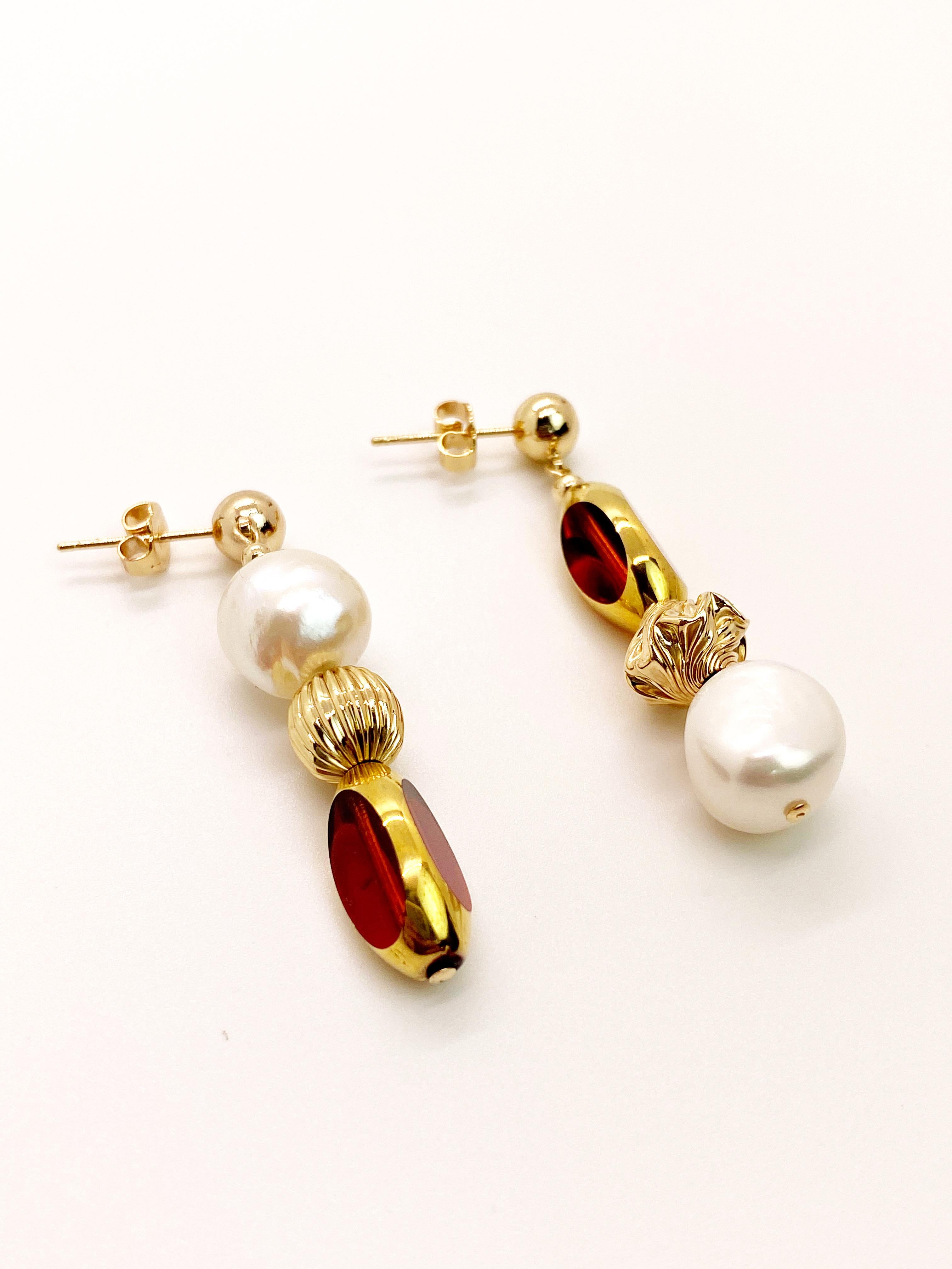 Amber Red colored vintage German window glass beads edged with 24K gold, freshwater pearls, gold filled textured beads on a 14K gold filled earring stud. Entire earring is about 1.8 inches. 

The vintage German glass beads are considered rare and