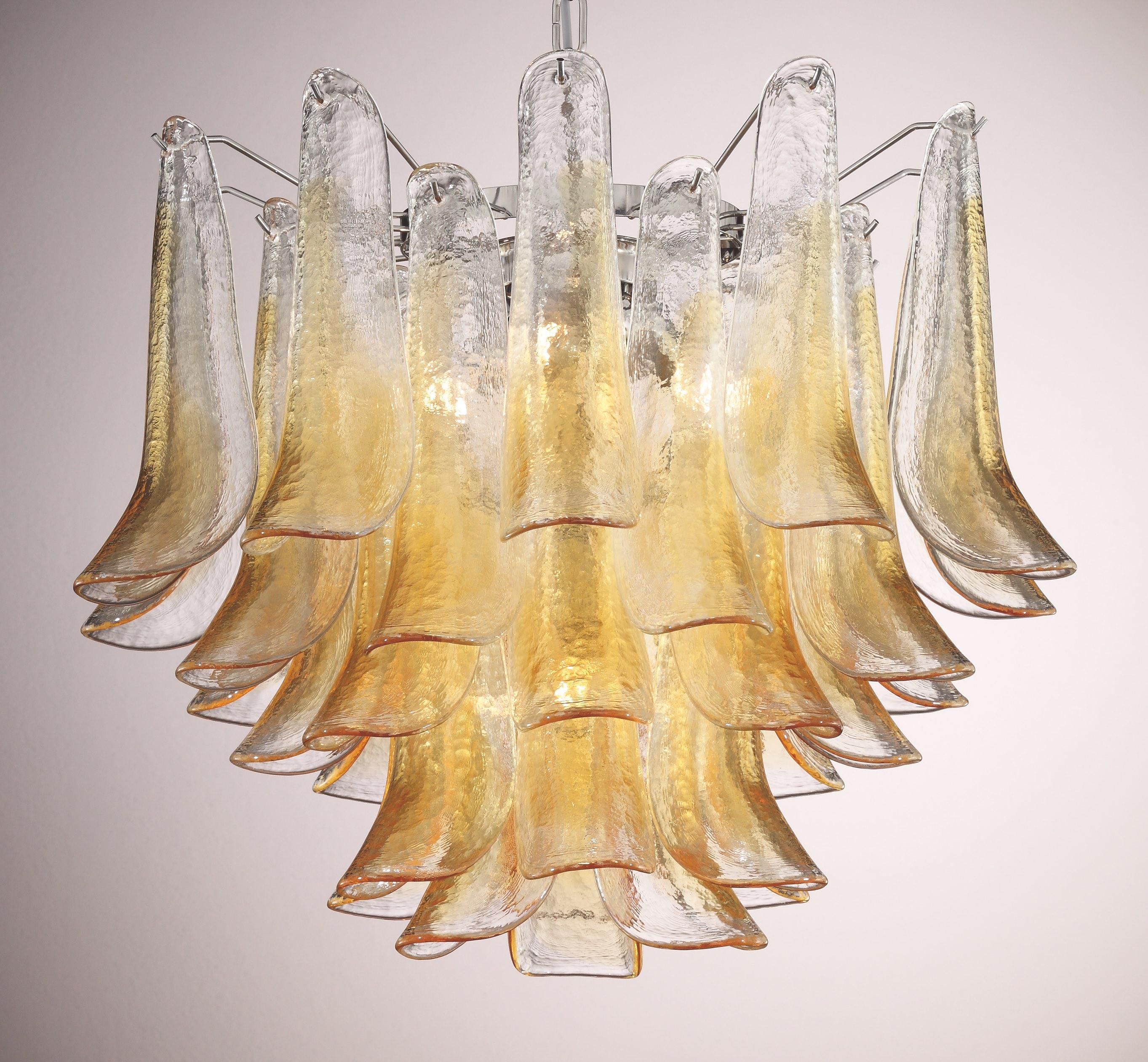 Italian chandelier shown with clear and amber Murano glass petals mounted on chrome finish metal frame / Designed by Fabio Bergomi for Fabio Ltd, inspired by Mazzega / Made in Italy
5 lights / E26 or E27 type / max 60W each
Measures: Diameter 23.5