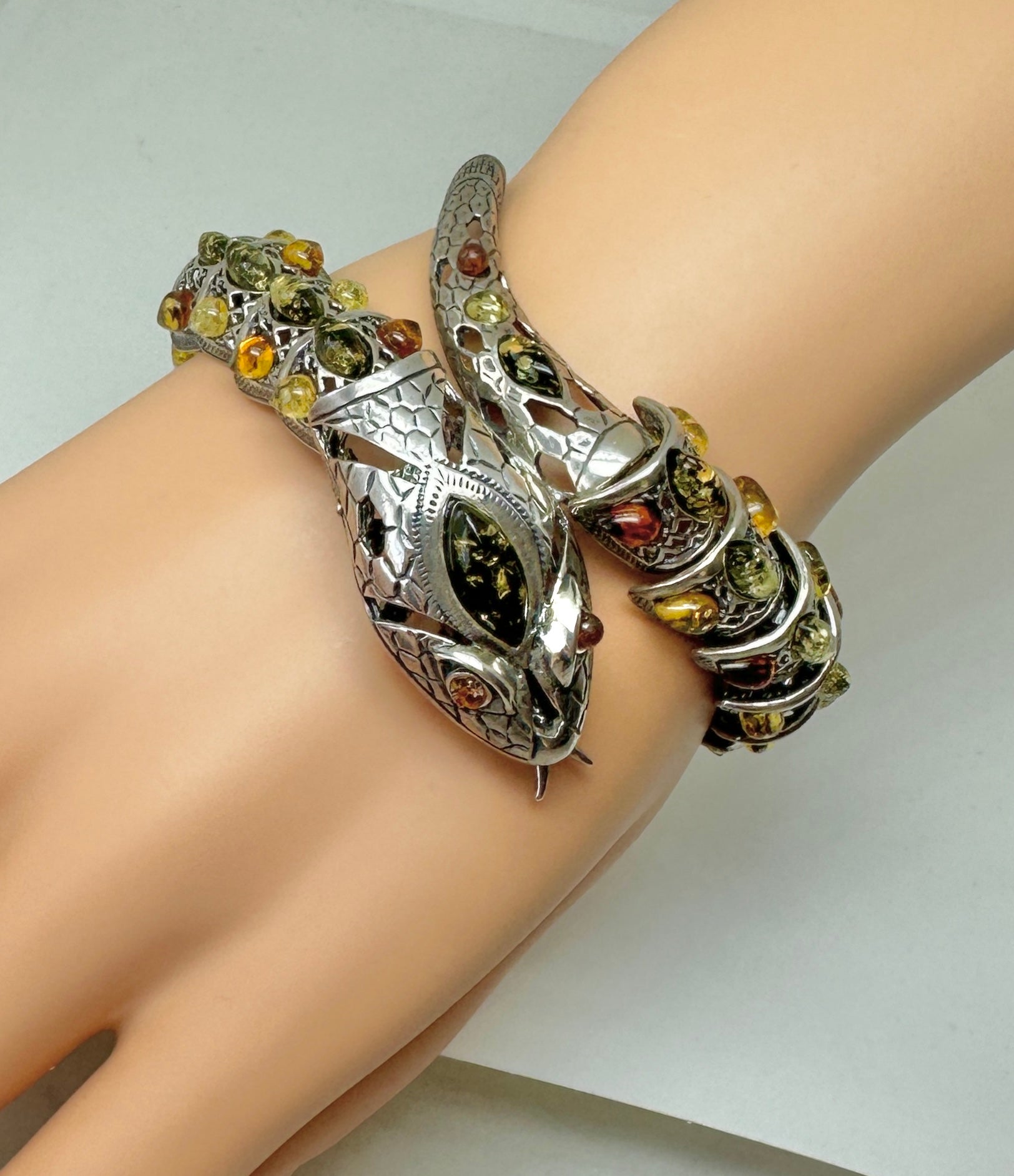 This is a wonderful Snake Bracelet in Sterling Silver set throughout with beautiful Amber gems.  The design is stunning with articulated sections each set with Amber in Sterling Silver.  The dramatic head of the snake is fabulous and the mouth opens