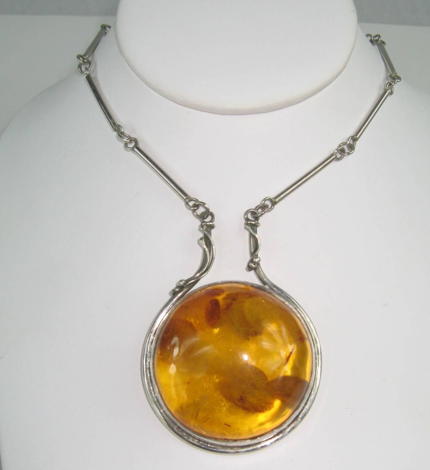 Huge chunk of Amber bezel set in Sterling of Handmade construction/ Bezel set amber Measuring 1.80 in and the Necklace 24 inches end to end. Pendant measures 2.20 inches top to bottom. This is out of a massive collection of Hopi, Zuni, Navajo,