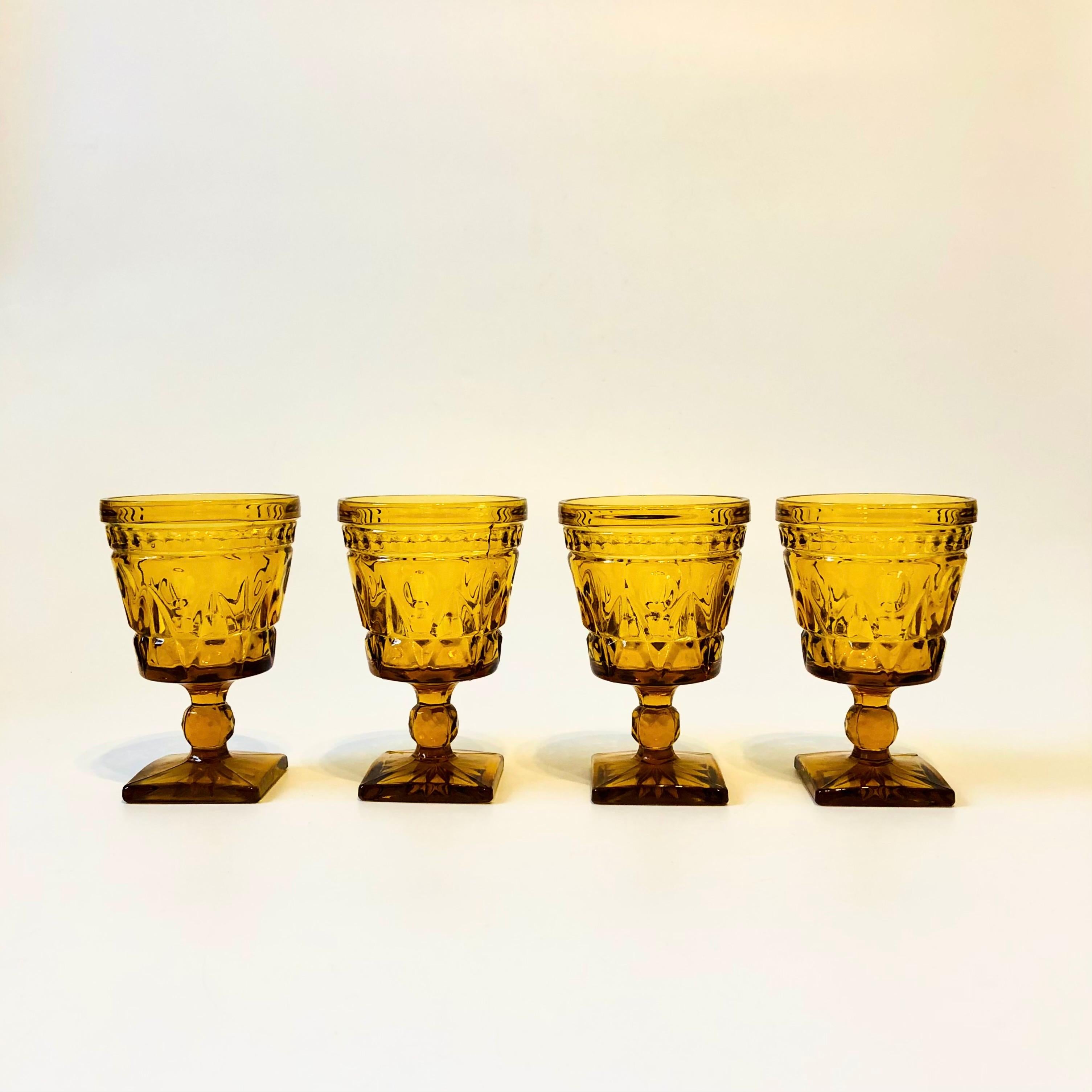 A set of 4 gorgeous wine goblets with a lovely ornate design in amber glass. Made in the 