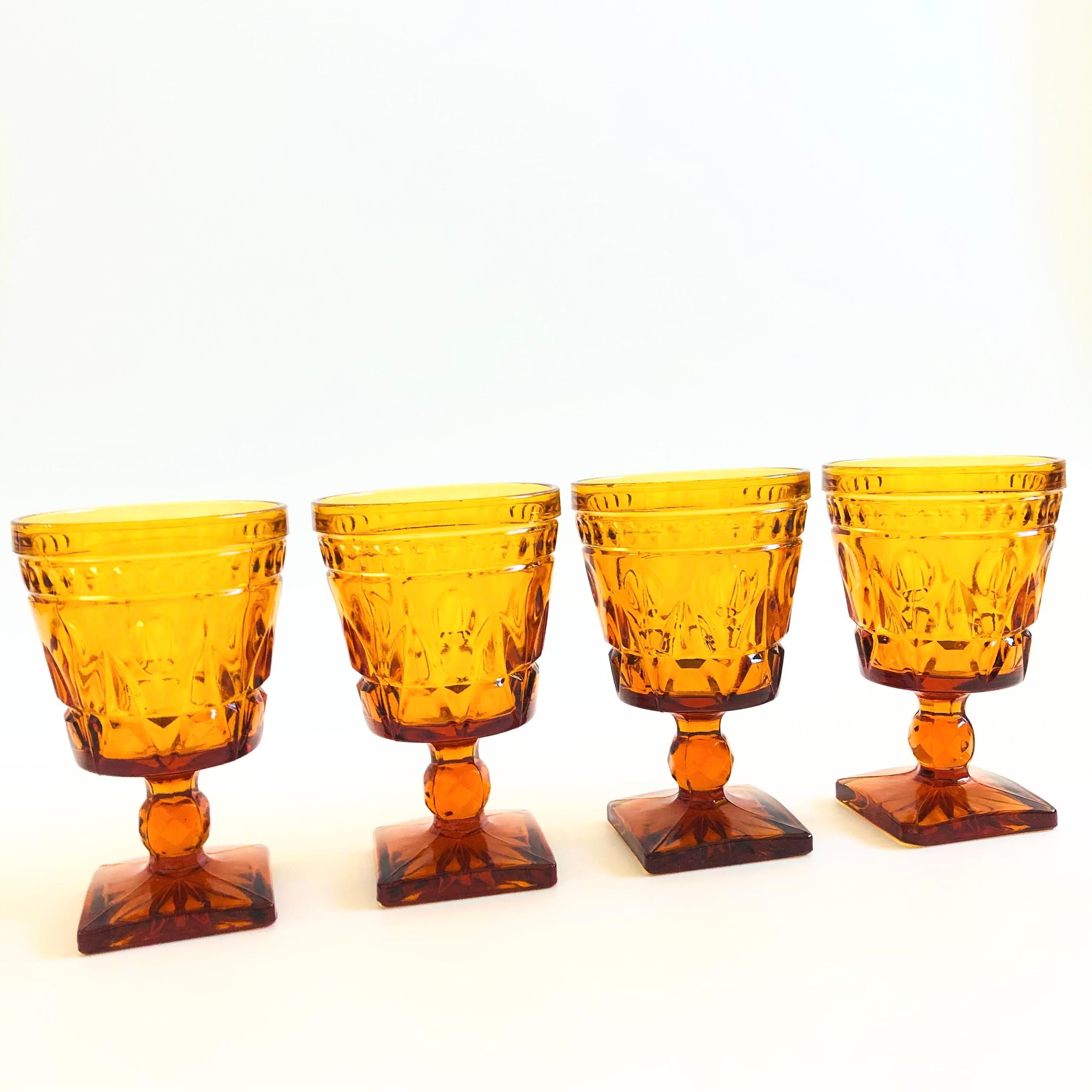 A set of 4 gorgeous wine goblets with a lovely ornate design in amber glass. Made in the 