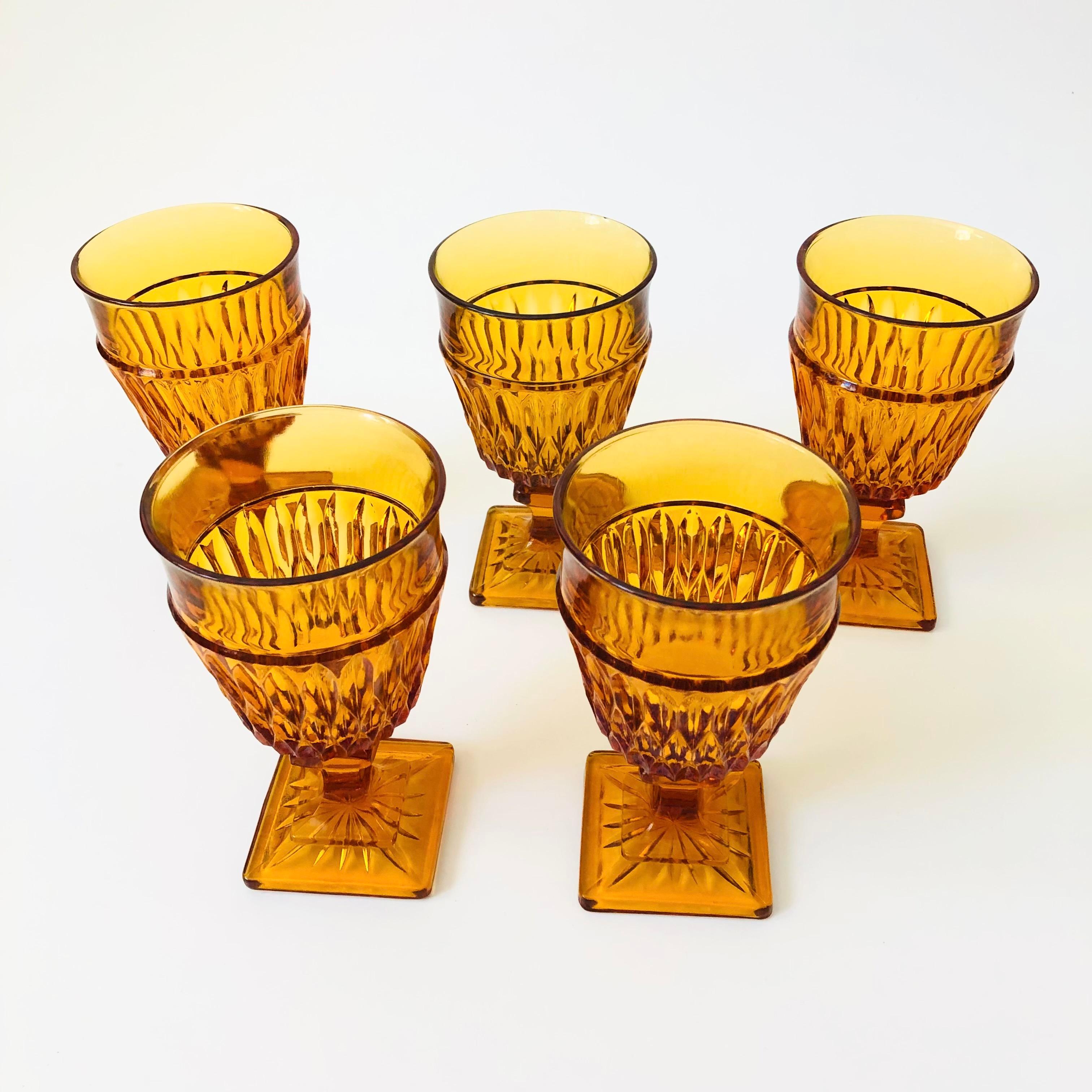 A set of 5 gorgeous wine goblets with a lovely ornate design in amber glass. Made in the 