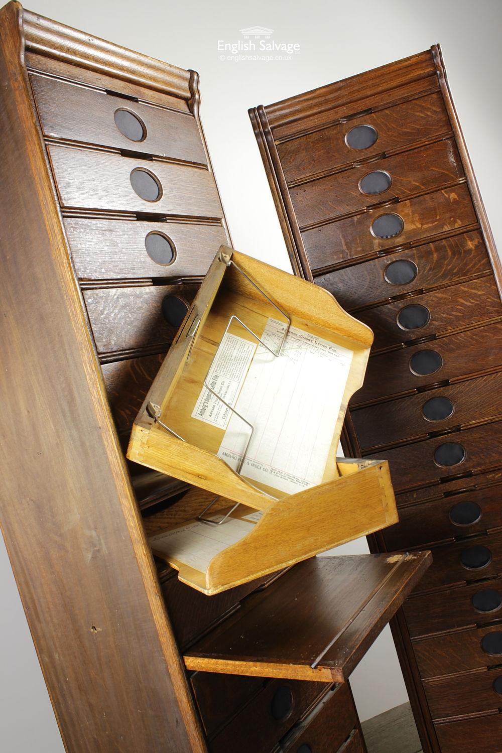 Fine pair of Amberg's Edwardian oak letter file cabinets comprising a stack of 15 drawers with oval plaques inset on front with panelled edges, with pull out shelves for ease of filing. Original paper still inside the spring clip drawers, some also