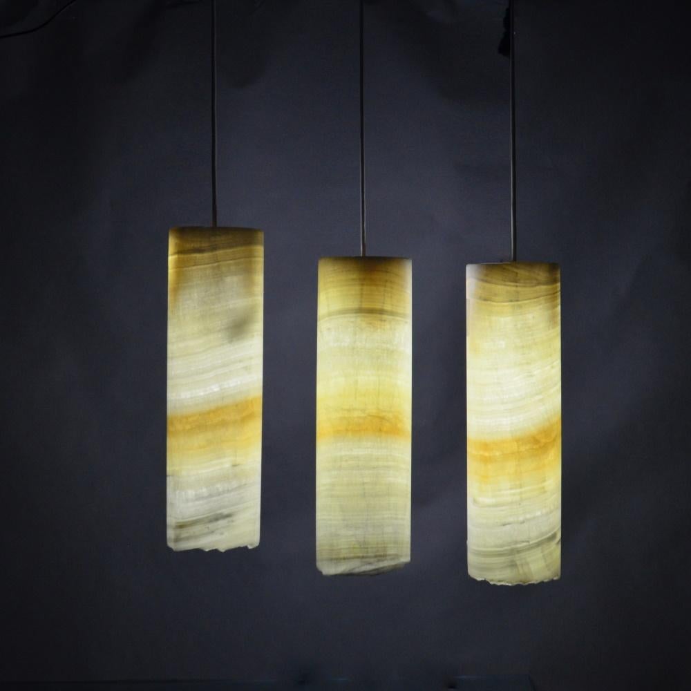 Cylinder ambient ceiling lamps in onyx. Beautifully handcrafted ceiling lamps from yellow onyx.