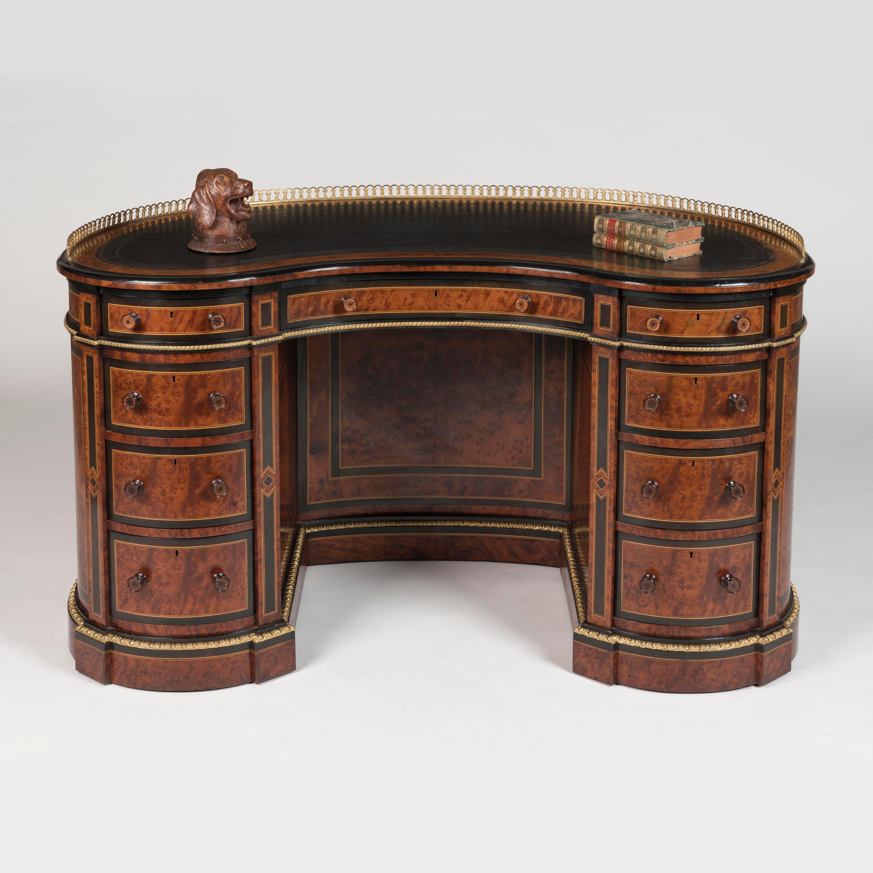 This magnificent kidney-shaped desk, attributed to the prestigious Gillows workshops, represents the epitome of Victorian craftsmanship and luxury. Created around 1870, this exceptional desk showcases the masterful blending of exotic materials and