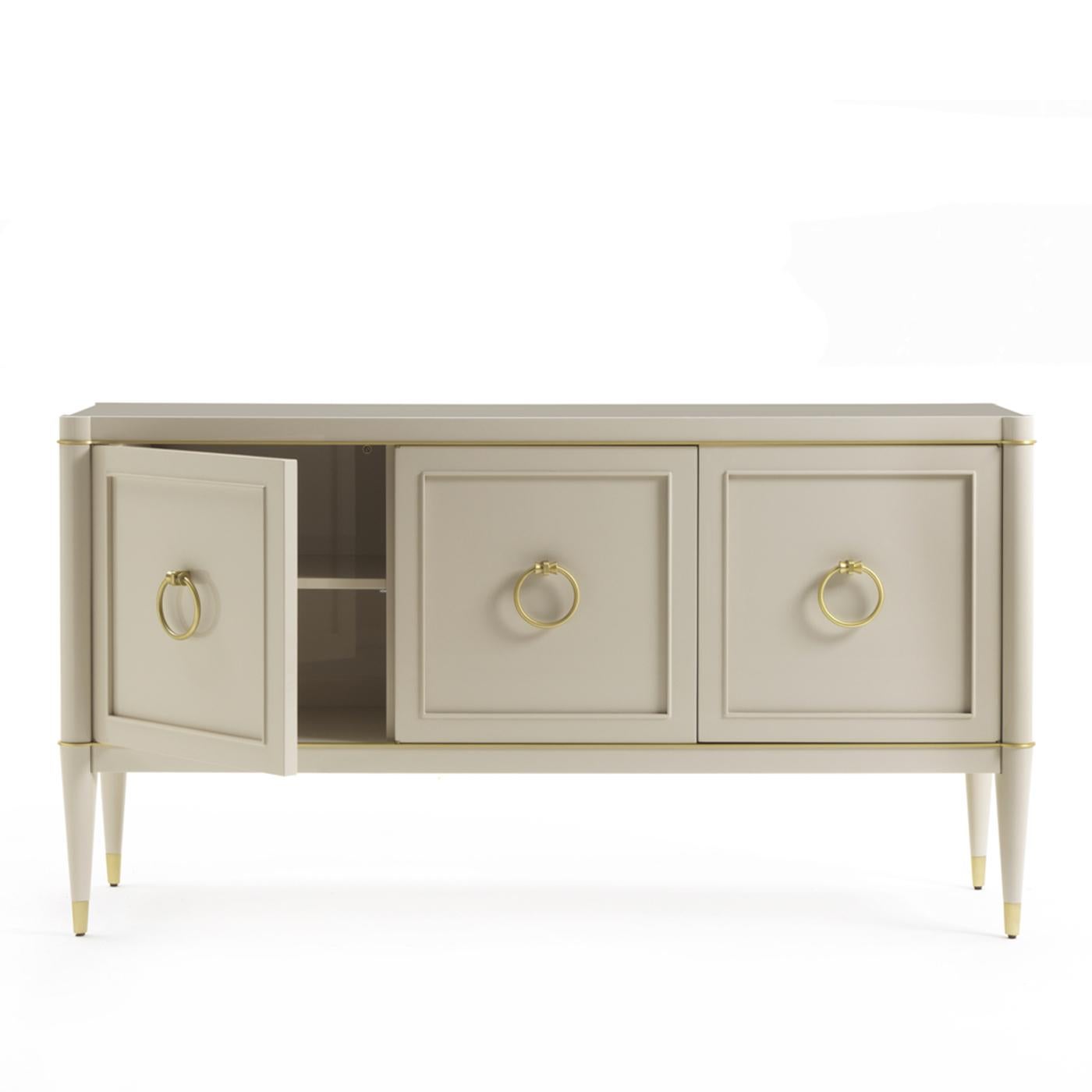 Part of the Ambra collection of elegant cabinets, this sideboard is a precious addition to a living room or dining room, where its exquisite silhouette will decorate a wall with subtle sophistication, while providing ample storage space and display