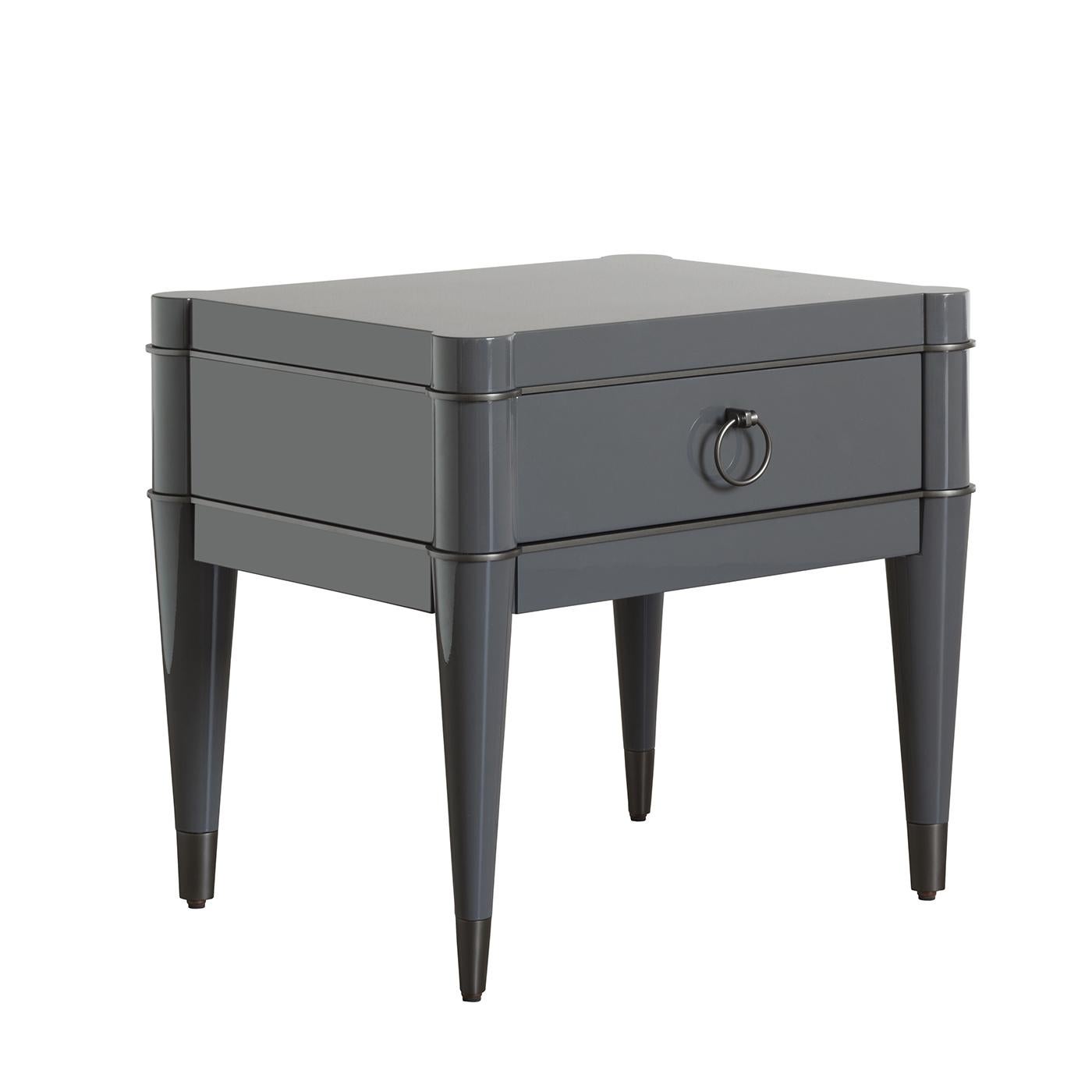 A charming addition to a bed frame, this nightstand is an exquisite presence in a classic home, thanks to its expert craftsmanship, high quality materials, and stunning details. The solid wood structure of this piece is adorned at the feet, around