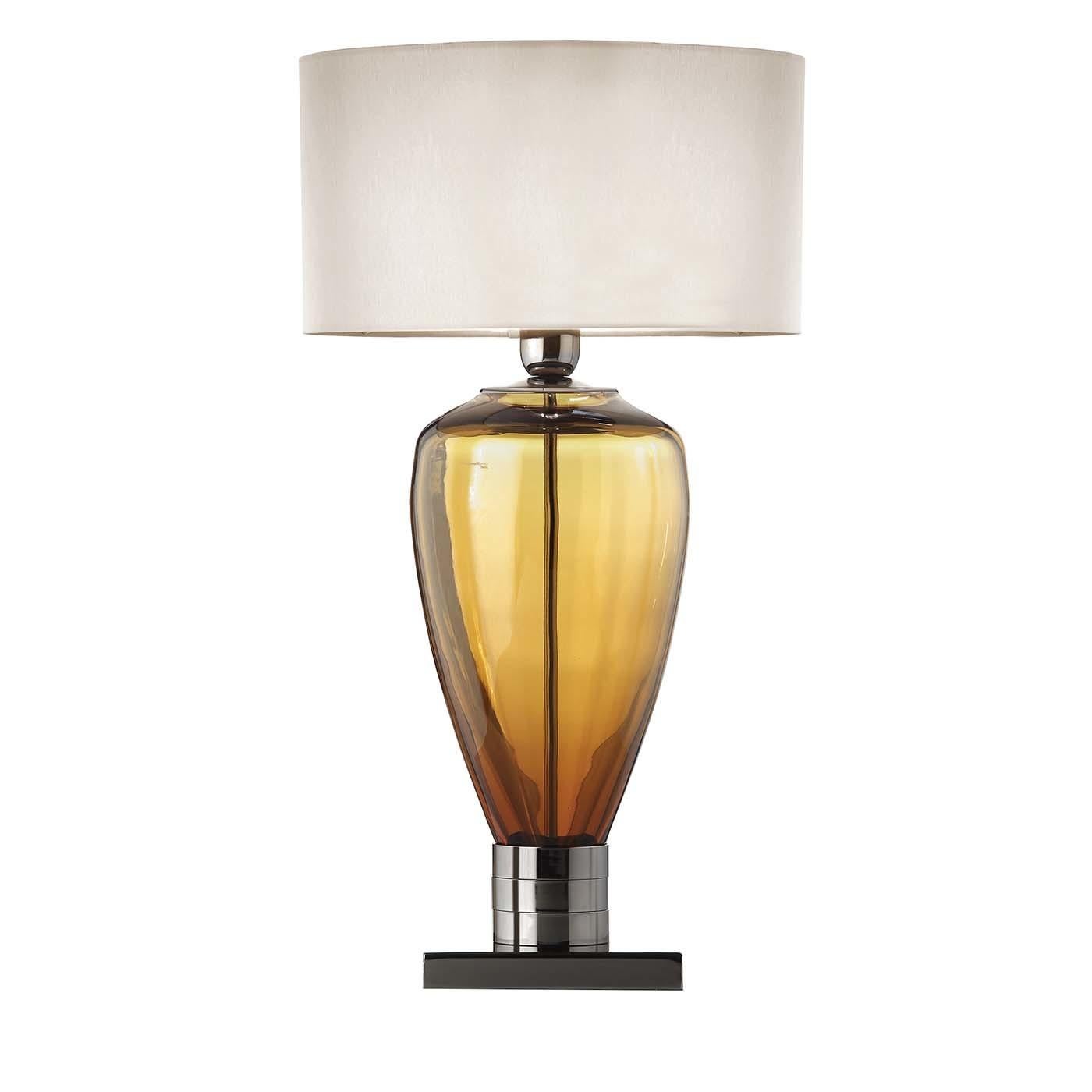 This stunning table lamp is the amber-hued version of the grey table lamp and can either be displayed as a pair for a dynamic effect or alone to add a sophisticated ambiance to a contemporary decor. The structure is a sinuous silhouette in 24 lead