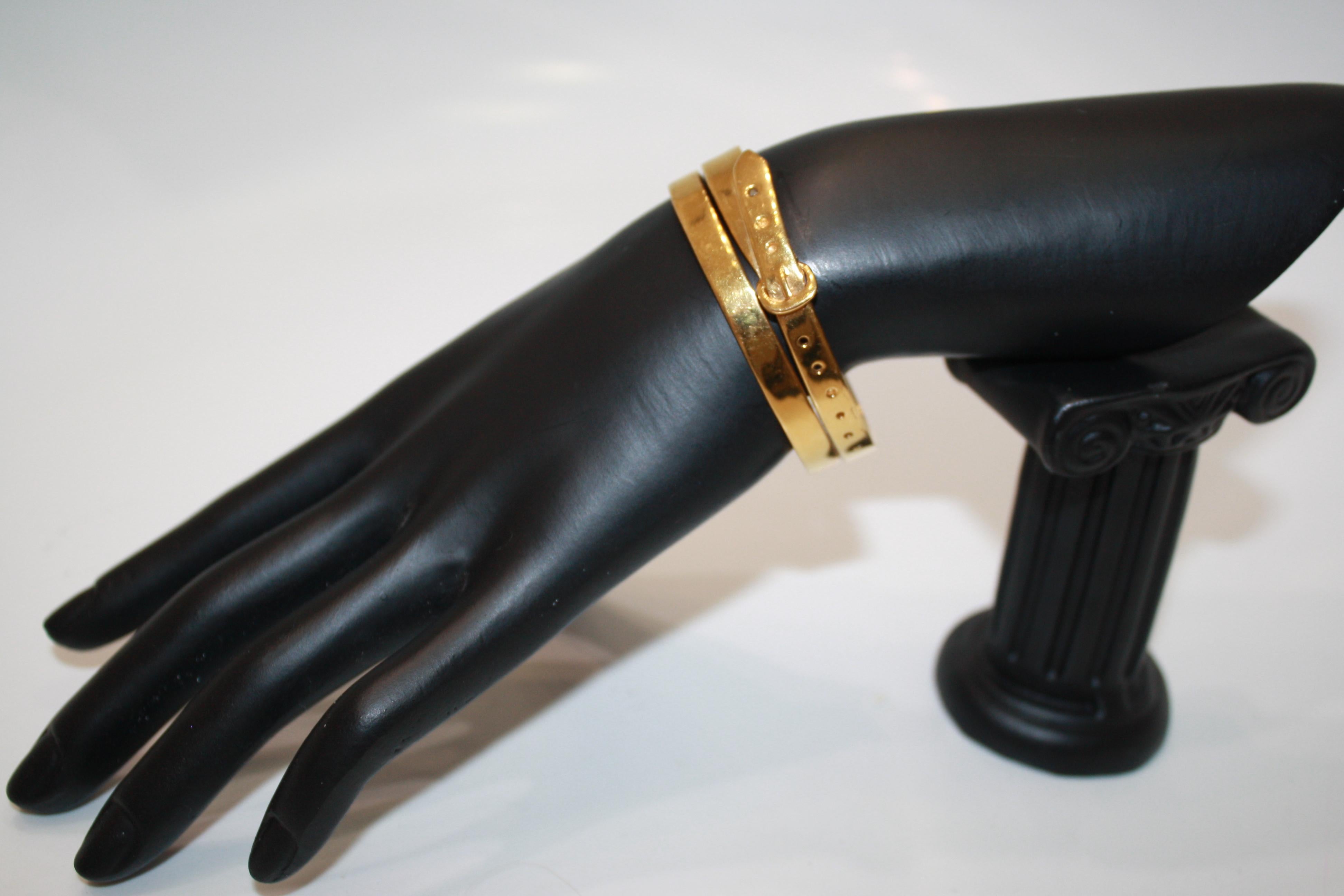 This double buckle cuff bracelet is hand made in a Parisian studio where it is dipped in an 18 carat gold bath. Cuff is malleable and can be adjusted to fit most wrist sizes. 