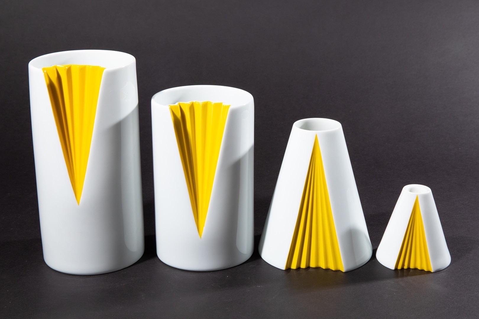 Set of 4 vases in white porcelain with a yellow colored glaze. Design by Ambrogjo Pozzi for Rosenthal Studio Line in 1985. The design is called plisse, and is modelled after a woman’s gown. The series was produced in 4 different sizes, and this set