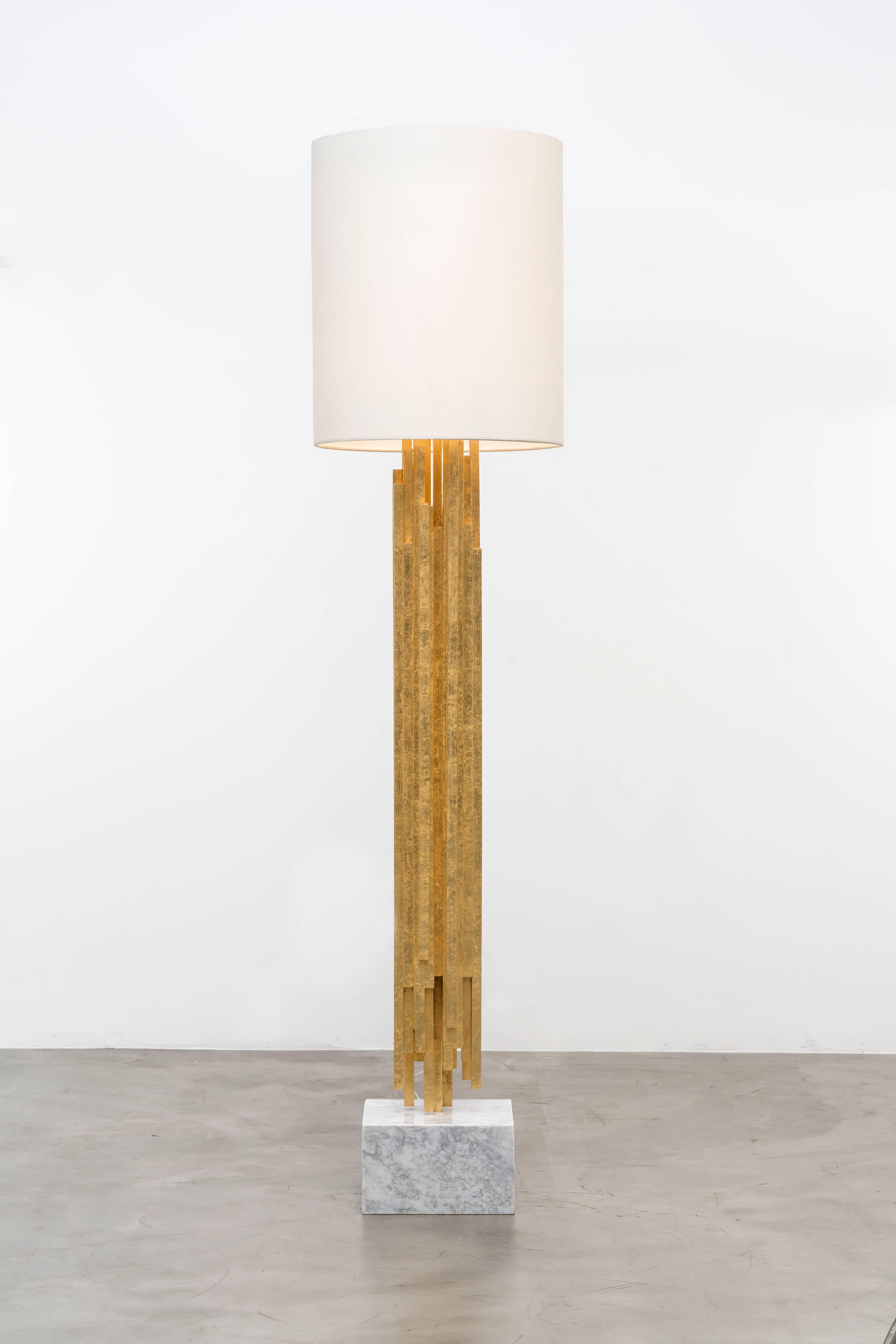 The Ambroise floor lamp is a sculptural fete featuring gold leafed wood. Polished brass, Carrara marble and a white linen shade finish this piece off. Light bulbs: One – standard medium base – 60 watt max (not included). This is a showroom sample