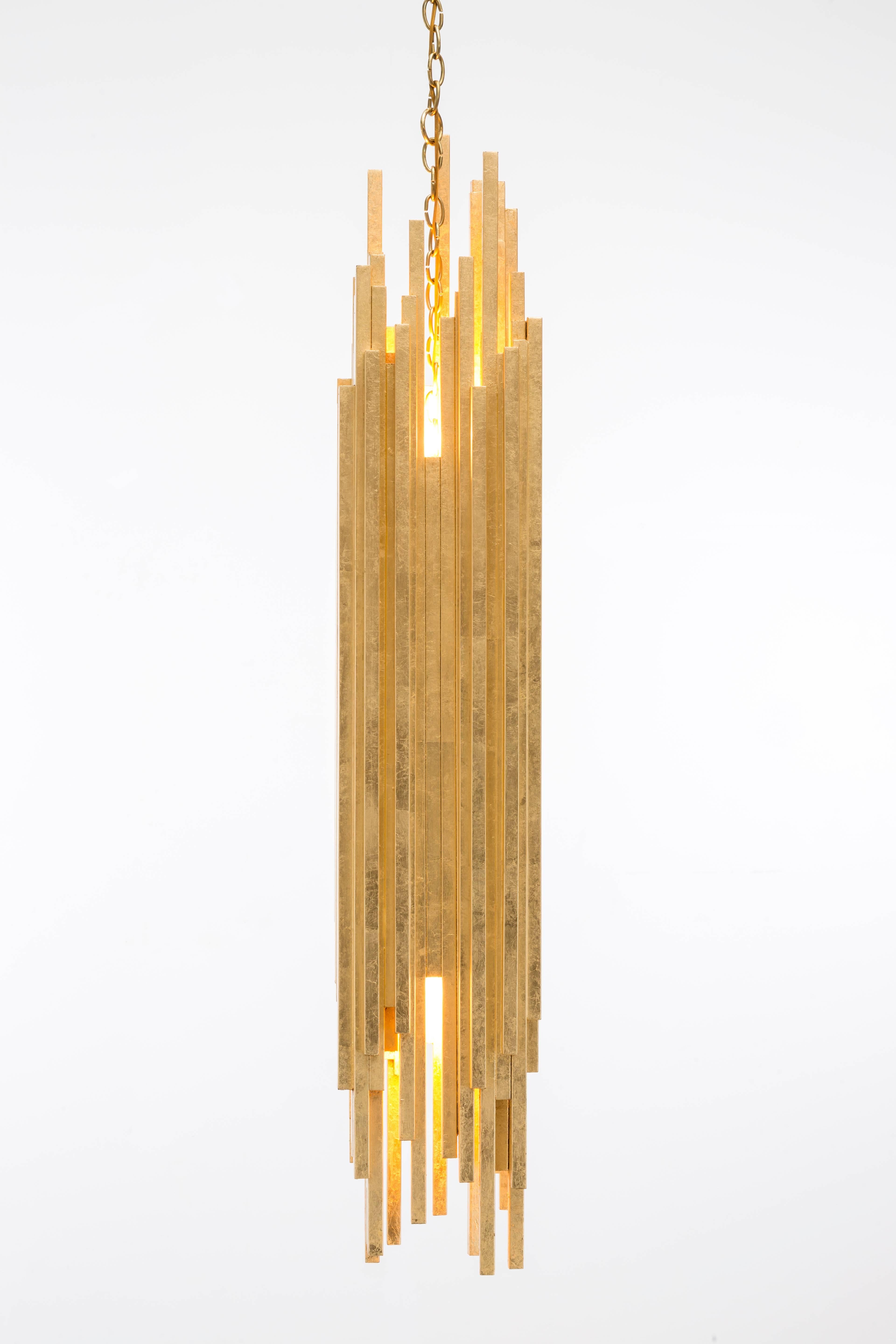 AMBROISE PENDANT - Modern Asymmetrical Gold Leaf Pendant 

The Ambroise Pendant is a stunning and unique lighting fixture that is sure to make a statement in any room. Crafted with gold leaf over wood, this pendant exudes luxury and sophistication.