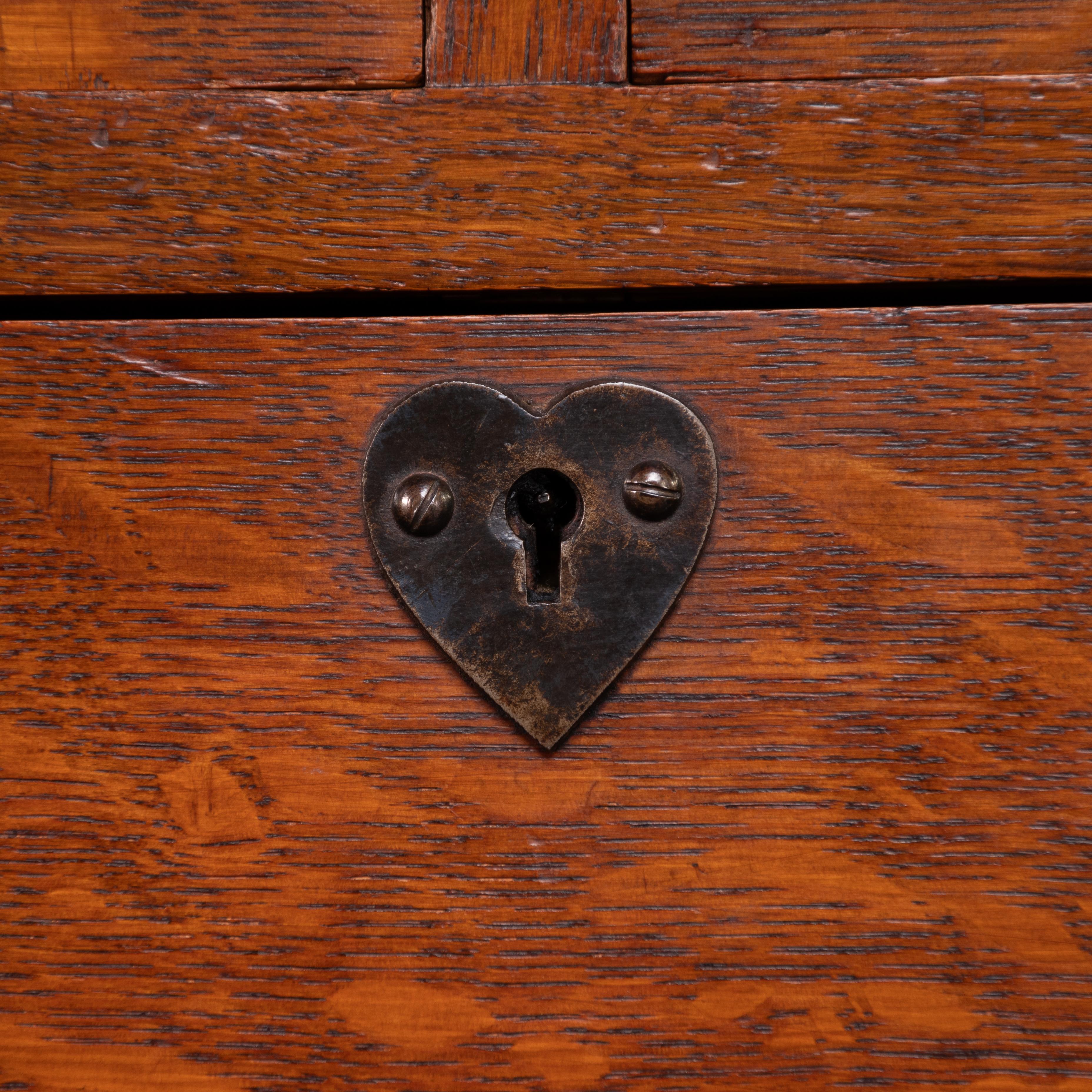 Ambrose Heal A Rare Mansfield Oak Chest of Drawers With Iron Heart Escutcheons In Good Condition For Sale In London, GB