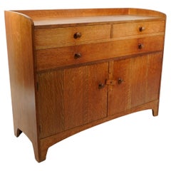 Ambrose Heal. An Arts and Crafts oak cottage sideboard or dresser