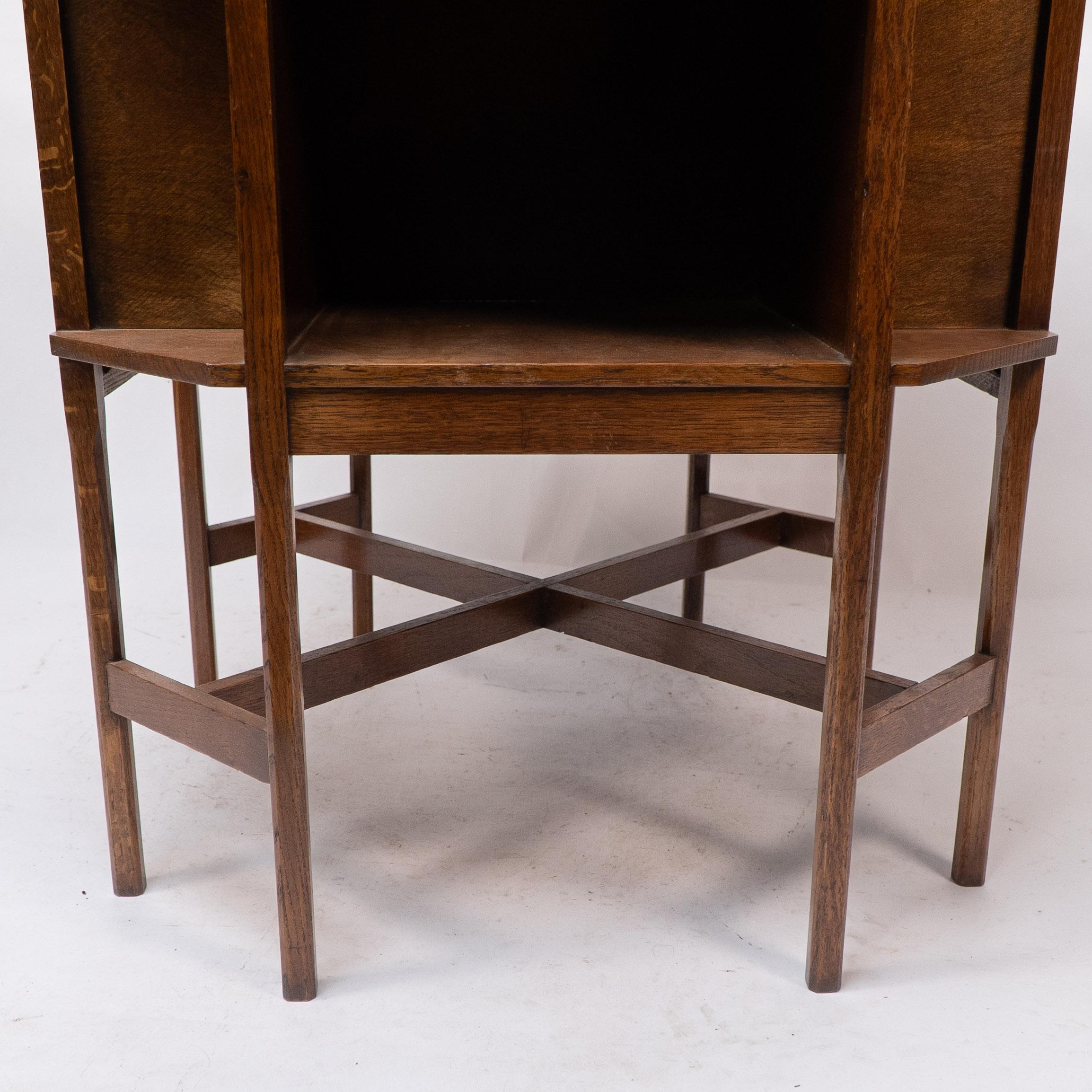 Ambrose Heals attri. An Arts & Crafts oak octagonal book table with eight legs 9