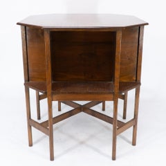 Ambrose Heals attri. An Arts & Crafts oak octagonal book table with eight legs