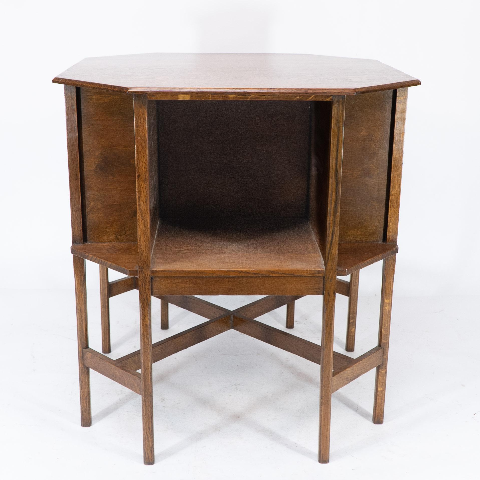 English Ambrose Heals attri. An Arts & Crafts oak octagonal book table with eight legs
