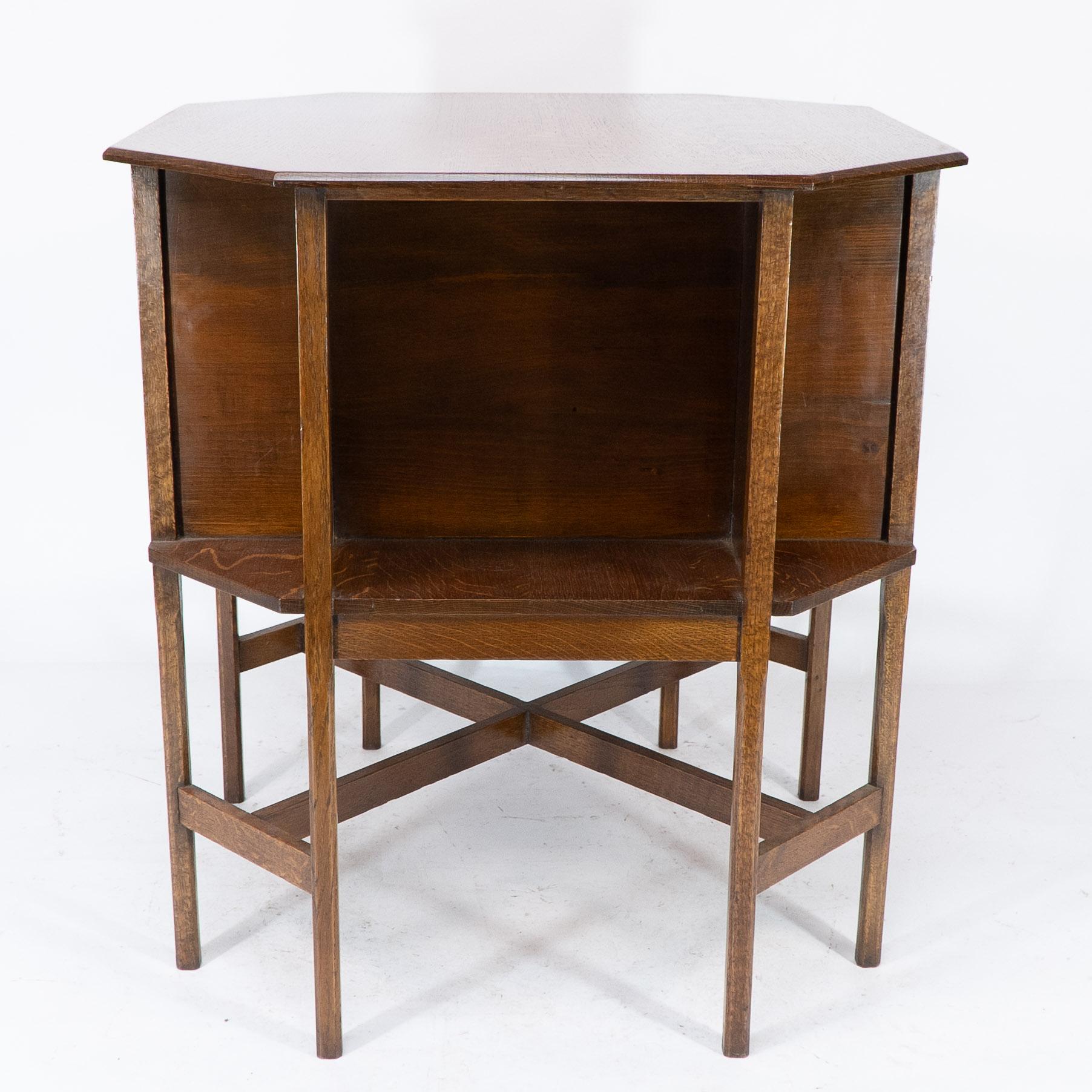 Early 20th Century Ambrose Heals attri. An Arts & Crafts oak octagonal book table with eight legs