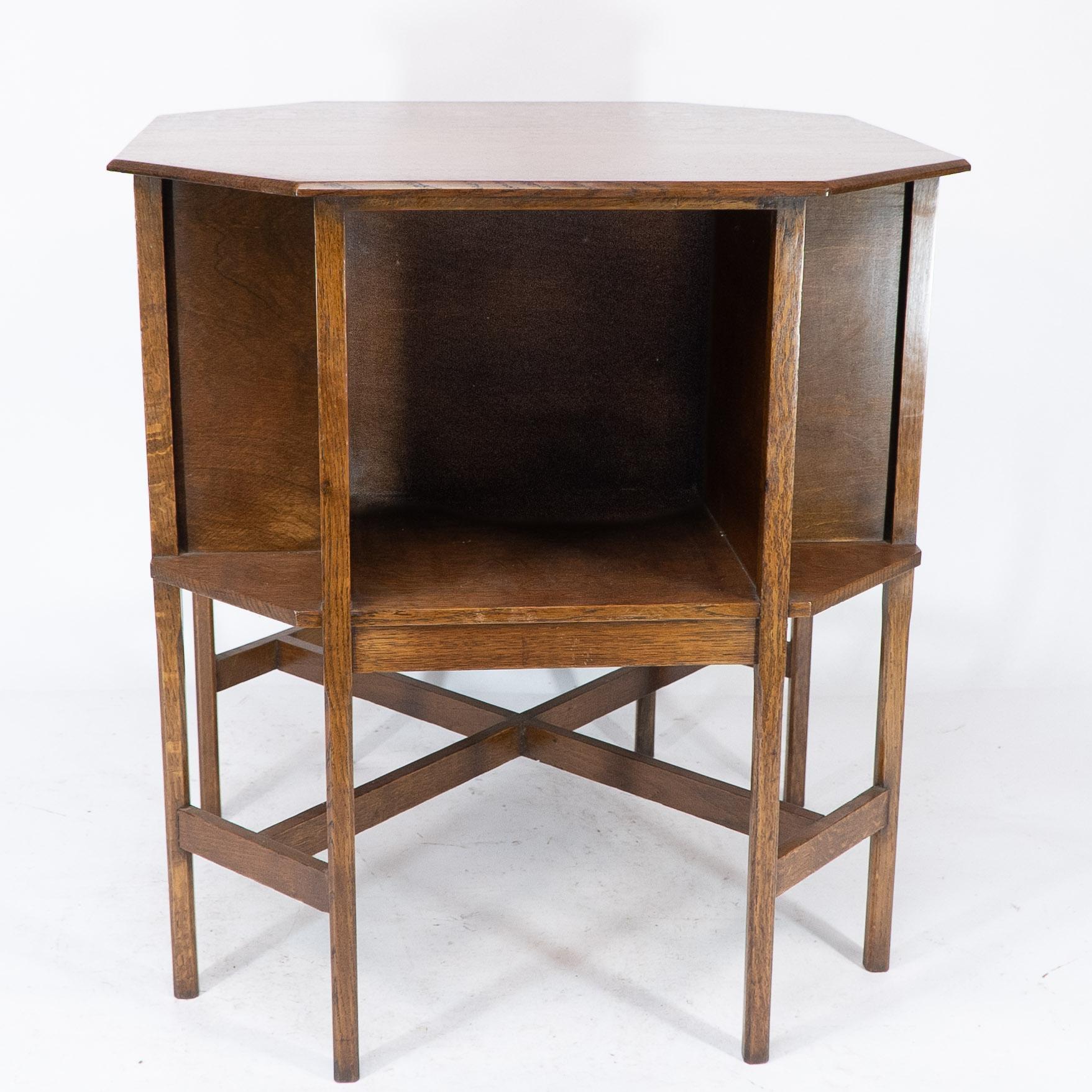 Ambrose Heals attri. An Arts & Crafts oak octagonal book table with eight legs 1