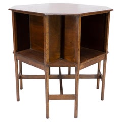 Ambrose Heals attri. An Arts & Crafts oak octagonal book table with eight legs