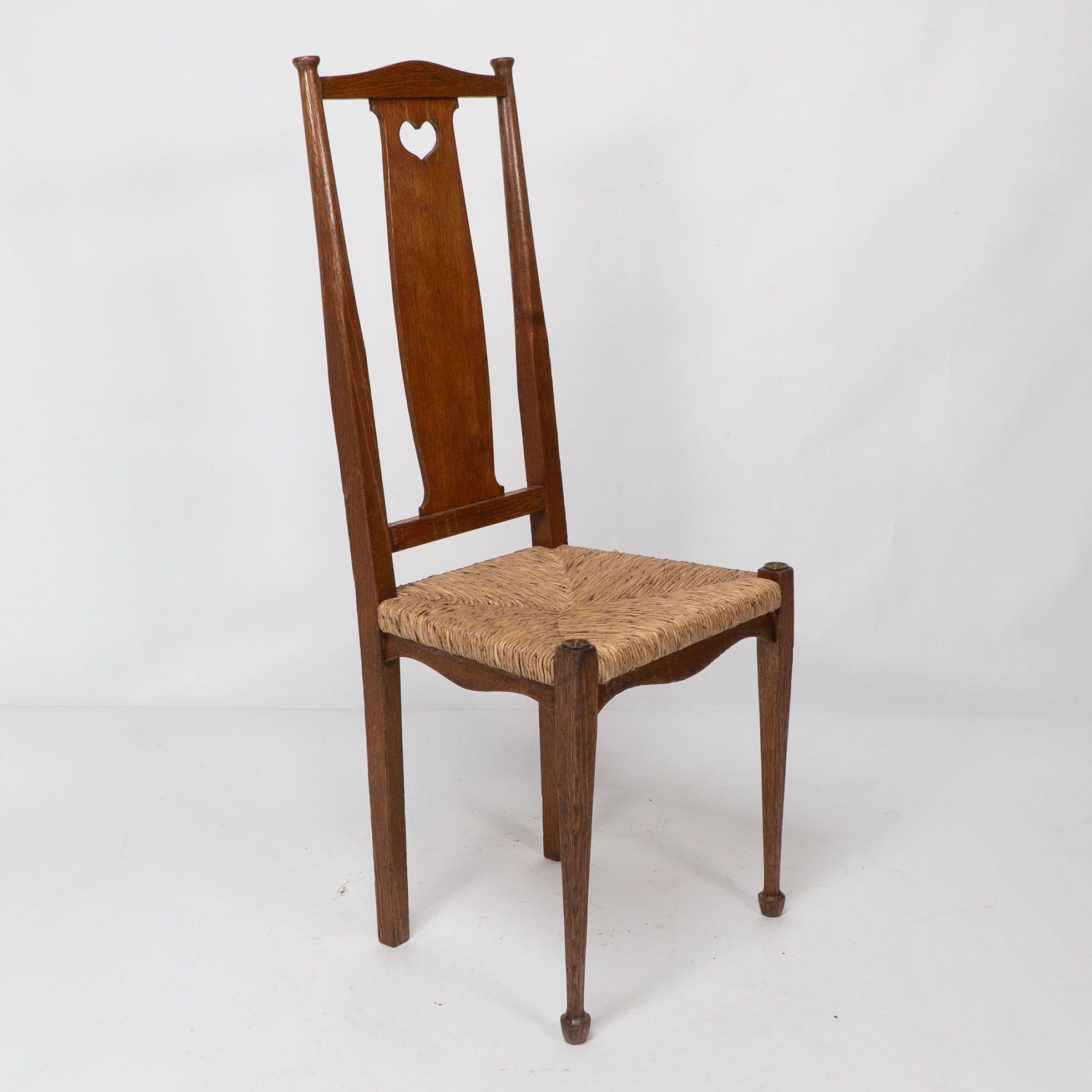 Late 19th Century Ambrose Heals for Heals of London. A pair of Arts and Crafts rush seated chairs For Sale