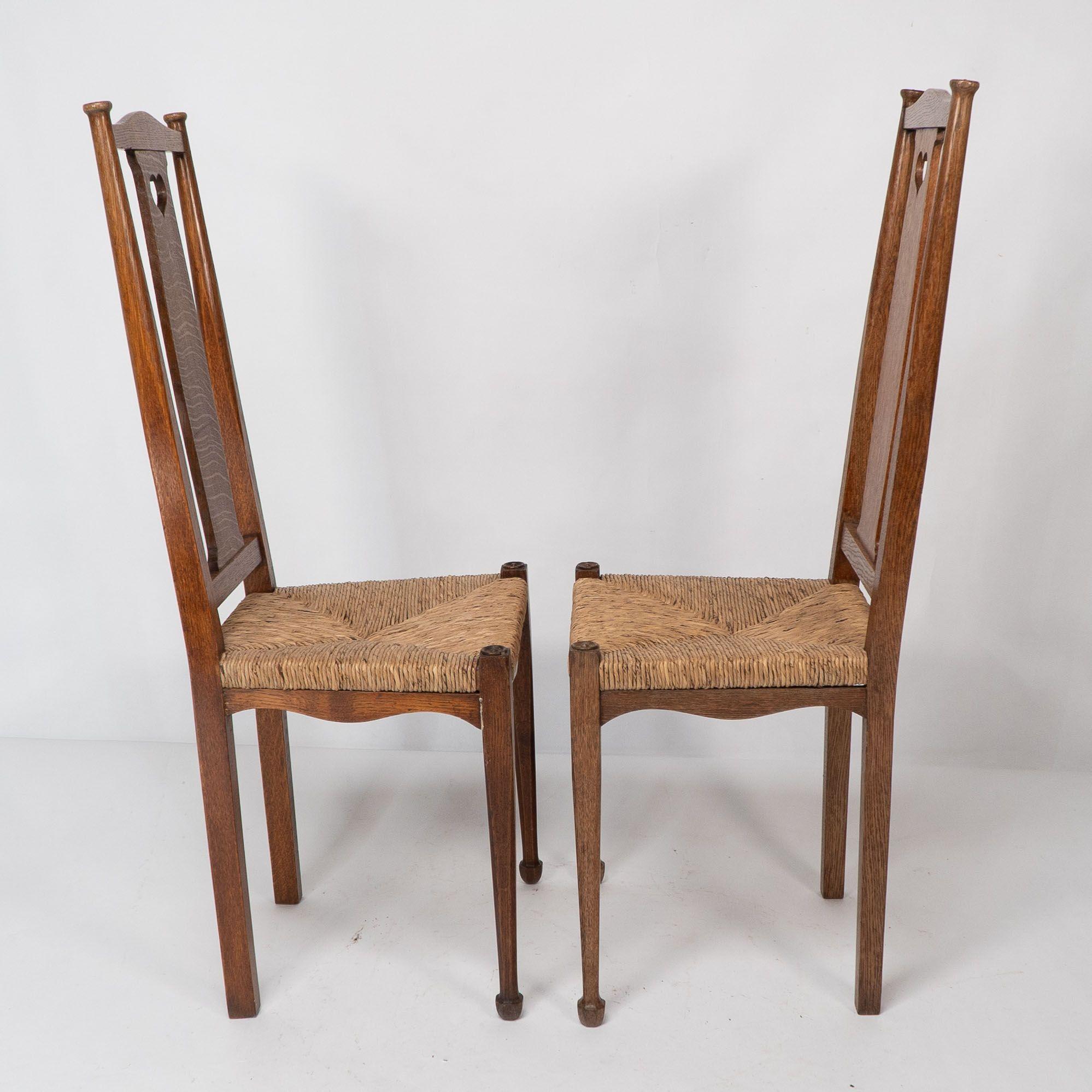 Rush Ambrose Heals for Heals of London. A pair of Arts and Crafts rush seated chairs For Sale