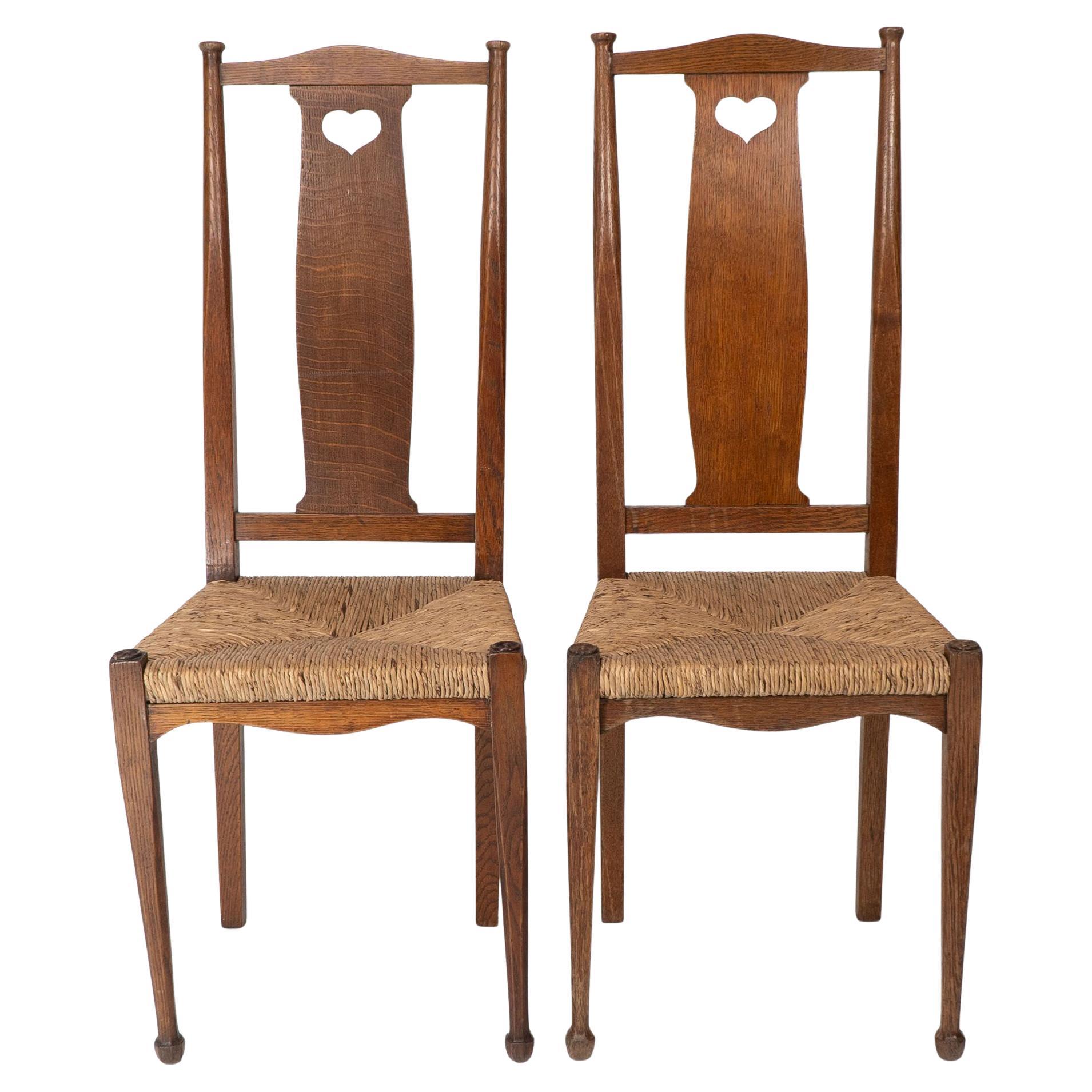 Ambrose Heals for Heals of London. A pair of Arts and Crafts rush seated chairs For Sale
