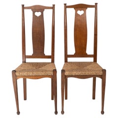 Ambrose Heals para Heals de Londres. Un par de sillas sentadas de junco Arts and Crafts