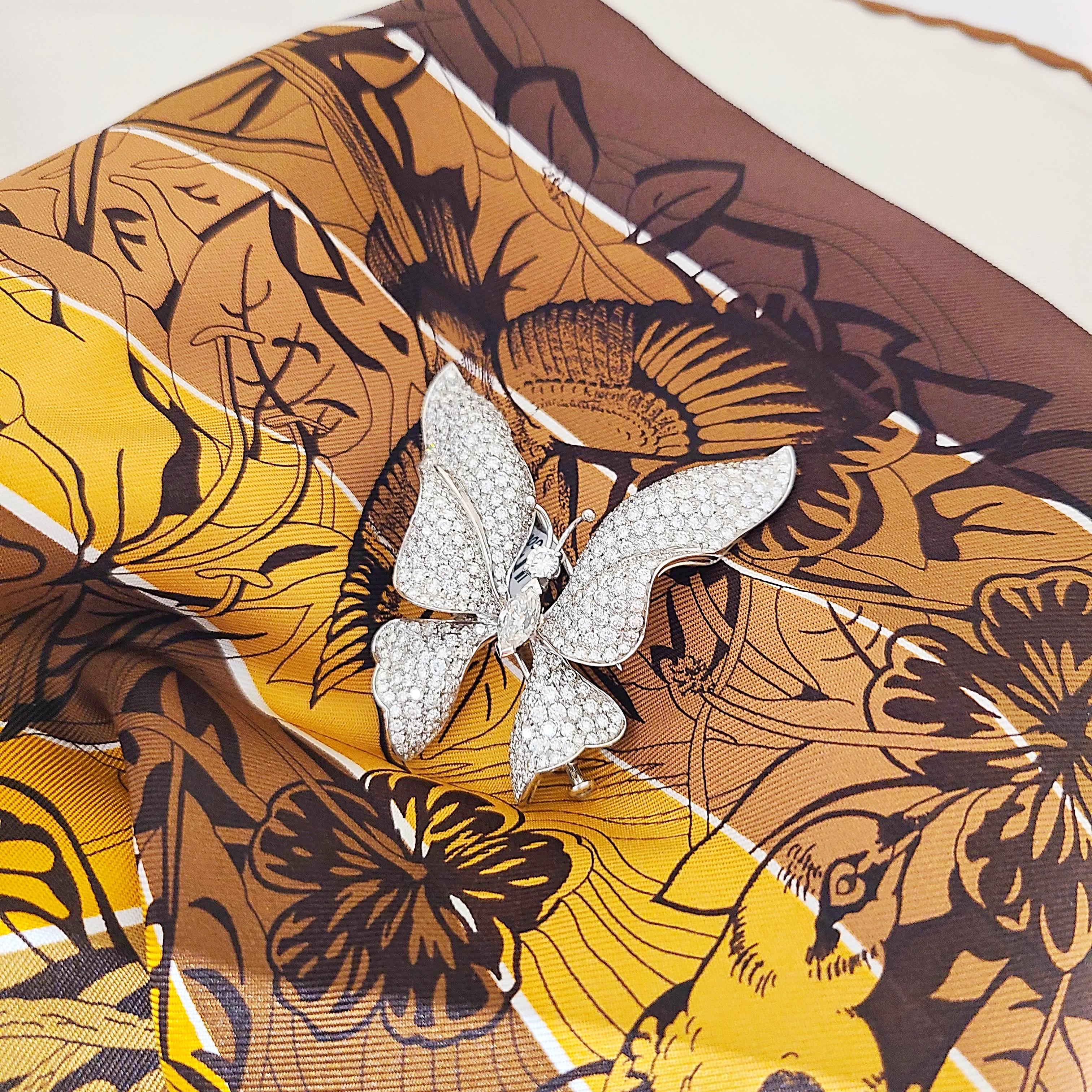 Schmetterlingsbrosche aus 18 Karat Weißgold. Die Flügel des Schmetterlings sind mit runden Diamanten besetzt. Das Zentrum ist mit runden Solitär-Brillanten und Marquise-Diamanten besetzt. Die Brosche misst 2,25 x 2 und hat eine doppelte