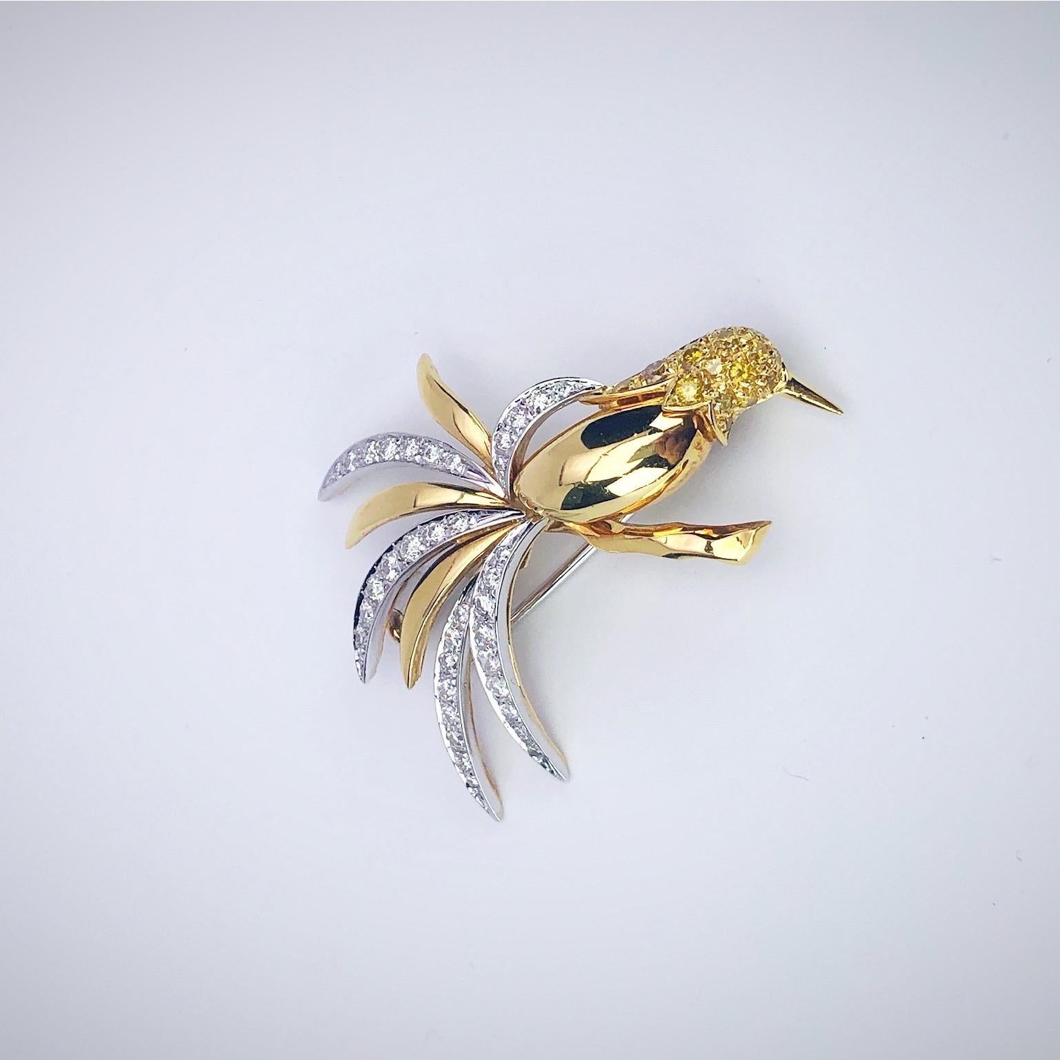 Lovely 18 karat yellow gold hummingbird brooch designed by Ambrosi of Italy.
The birds head is set with round brilliant yellow diamonds, the feathers are set with round brilliant white diamonds and the body is a hi- polished yellow gold. The pin's