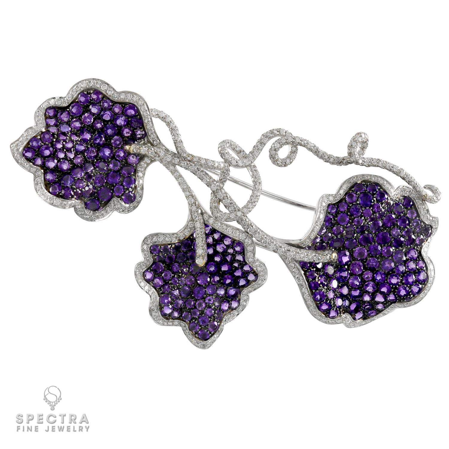 This charming De Ambrosi Contemporary Amethyst and Diamond Brooch made in Italy in the Contemporary Era, circa 2010s, makes one think of the refreshing shade under a trellised grape arbor in the heat of August. The pin features three unmistakable