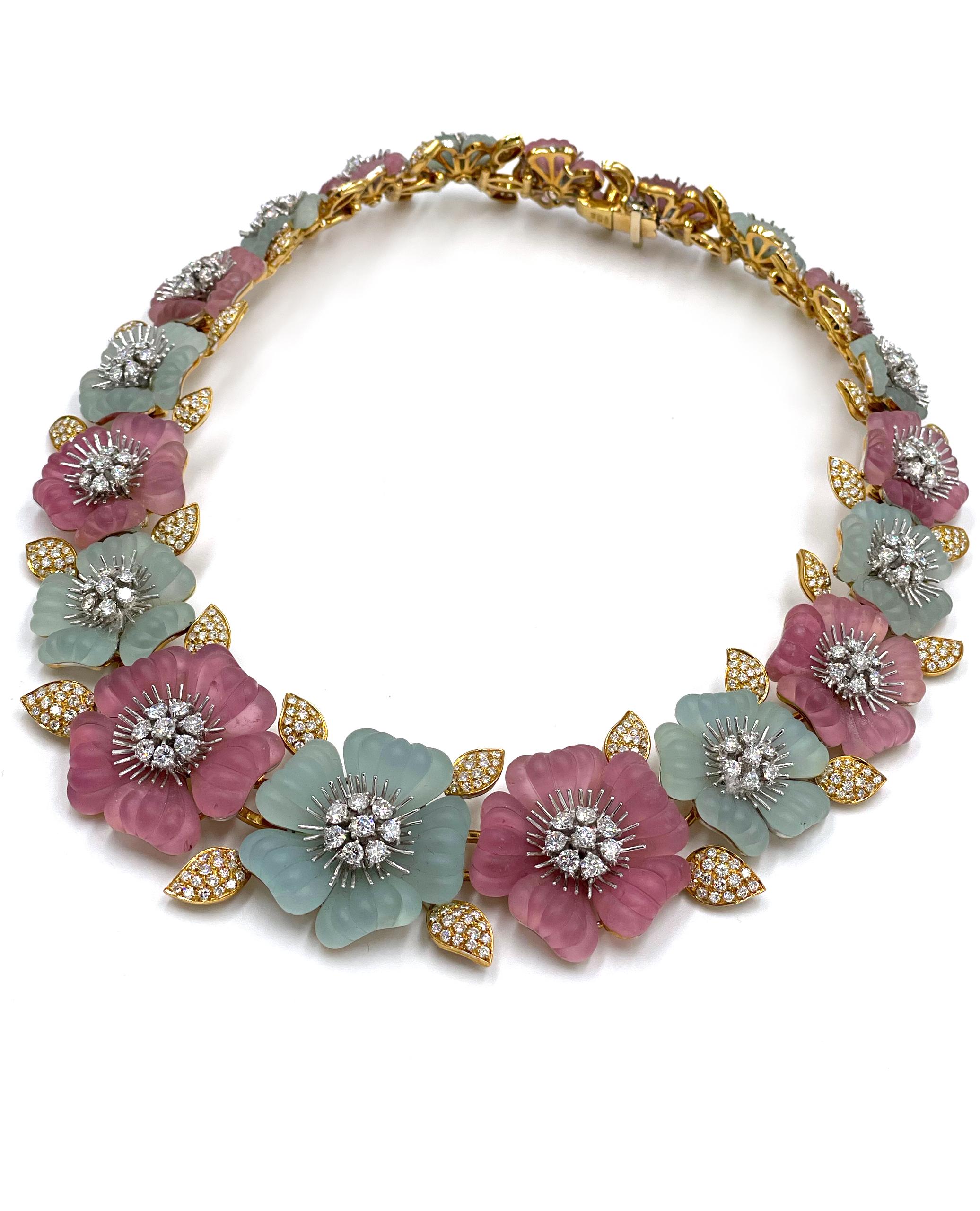 Pre owned vintage estate Ambrosi 18K white and yellow gold one of a kind aquamarine, pink tourmaline and diamond floral necklace.  The hand crafted necklace consists of 10 hand carved flowers alternating pink tourmaline and aquamarine.  The center