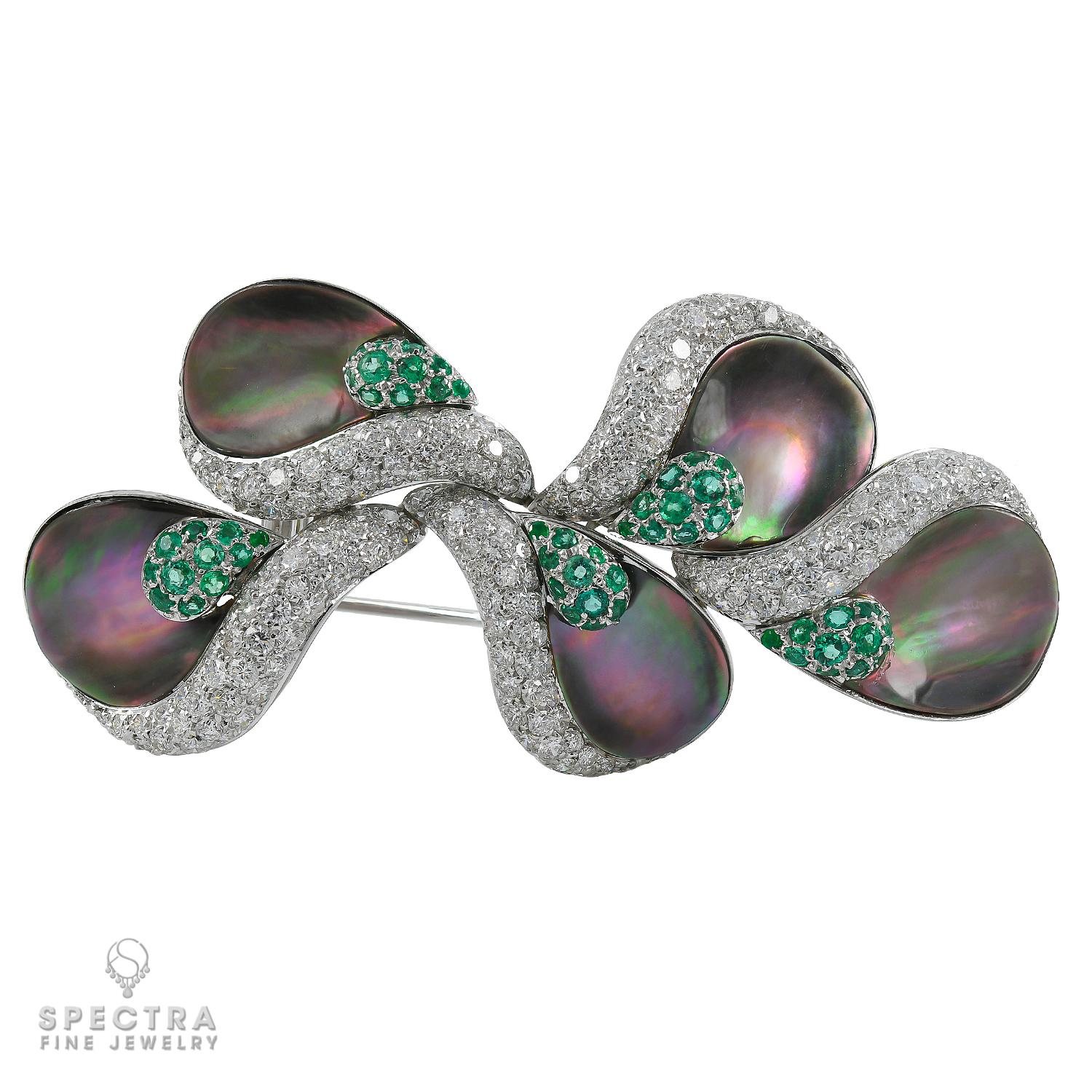This mysterious double pinstem De Ambrosi Contemporary Brooch, made in Italy in the Contemporary Era, circa 2010s, features deeply fascinating organic forms, crafted in 18K white gold and set with a host of sensual gems. Iridescent mother-of-pearl