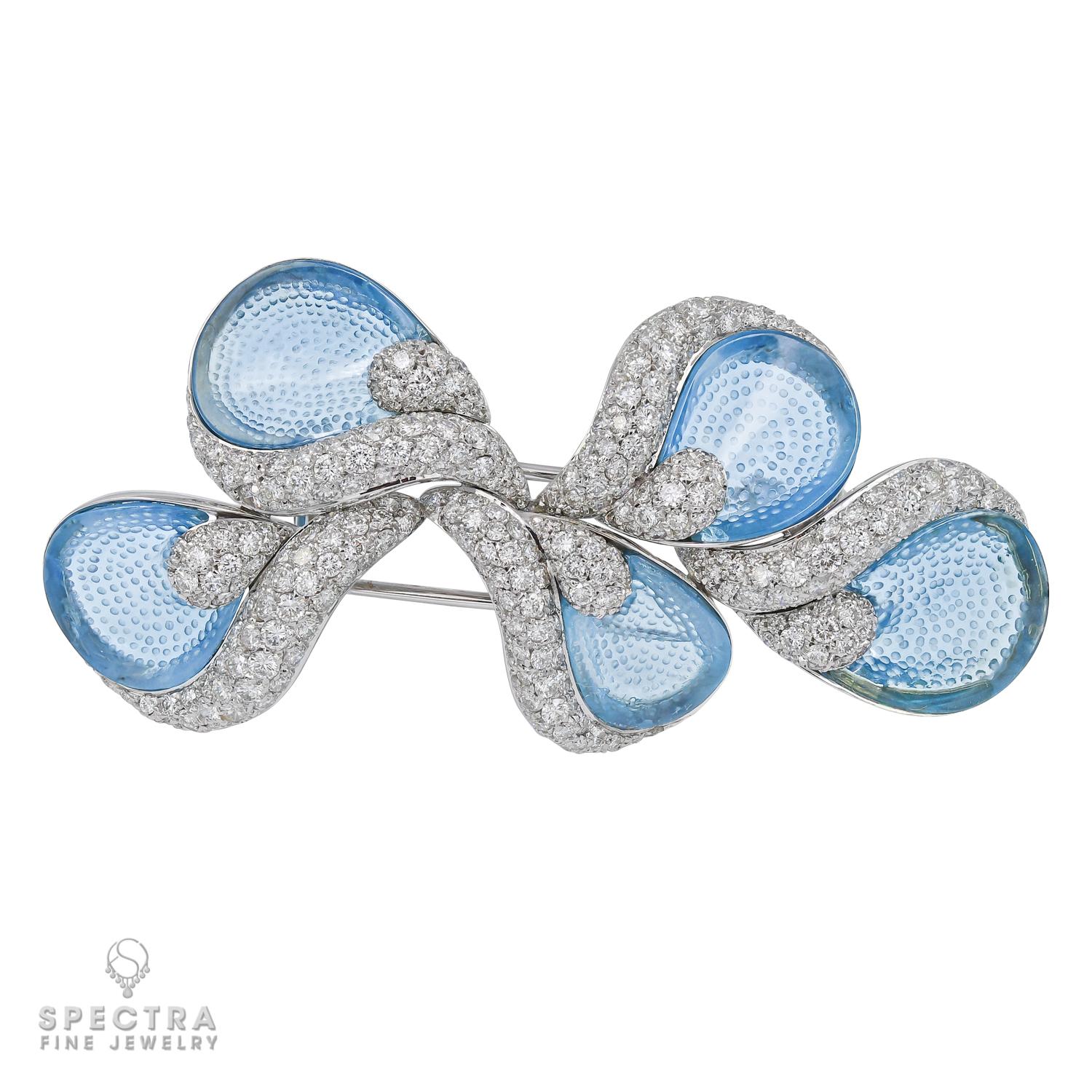 Behold the epitome of sophistication and artistry in the Ambrosi Carved Blue Gemstone Brooch - a masterpiece that seamlessly marries timeless elegance with the allure of exquisite craftsmanship. Fashioned in the lustrous embrace of 18K white gold,