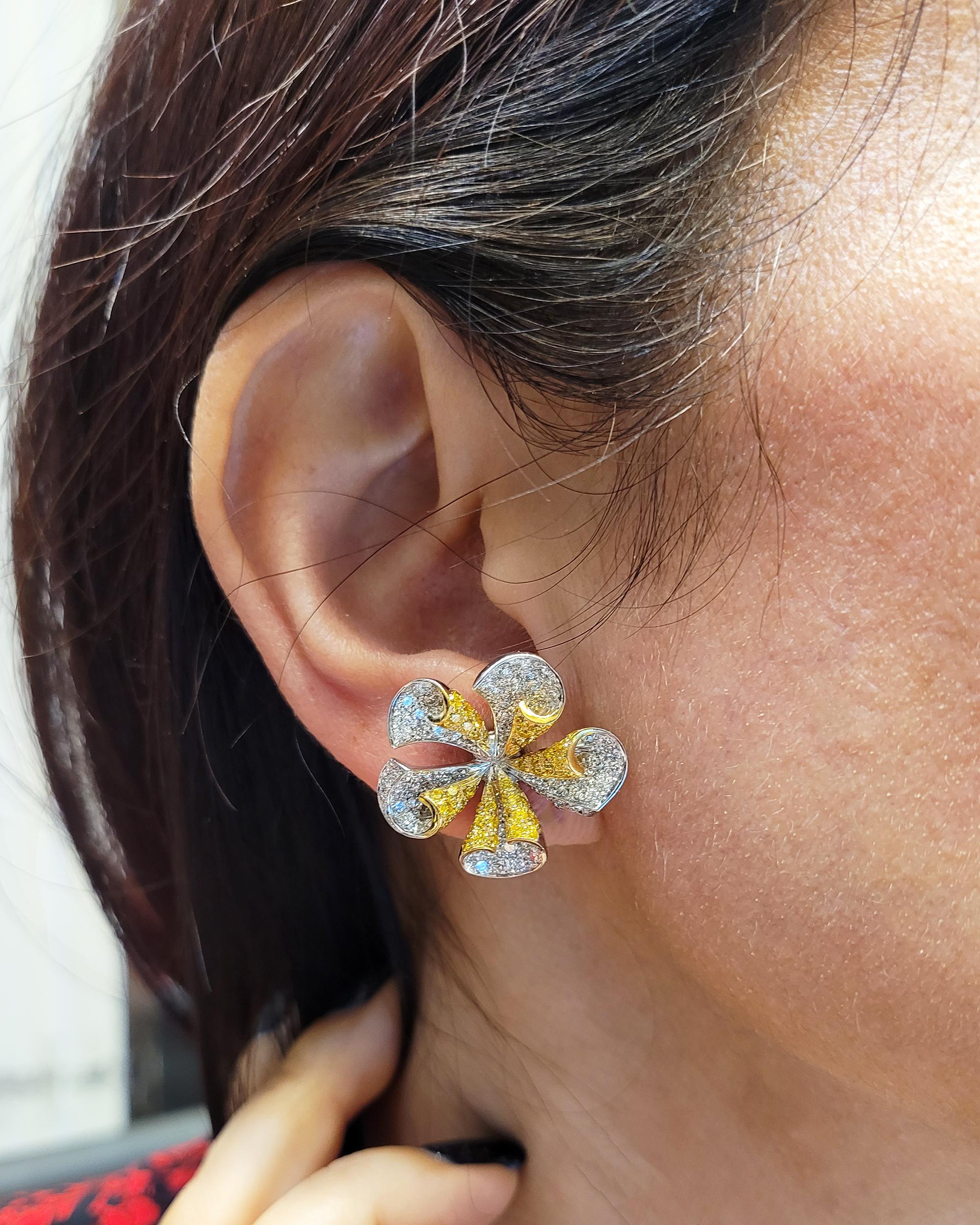 Beautiful flower earrings created by the Italian jeweler Ambrosi.
Embellished with round brilliant-cut yellow diamonds, weighing approximately 1.95 carats.
White round brilliant-cut diamonds, weighing approximately 3.43 carats, G-H color and VS
