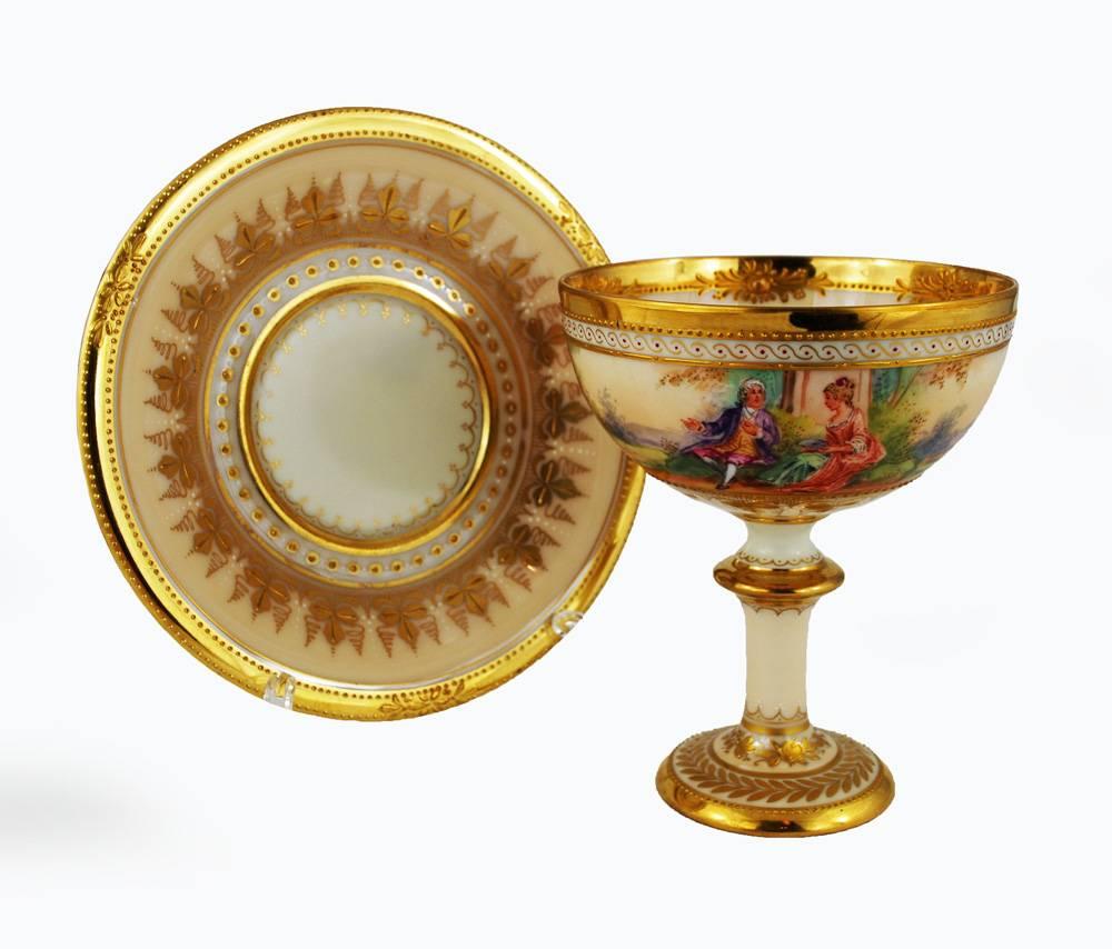 Cup has a hairline

A delicately painted footed cup and saucer by Ambrosius Lamm studio in Dresden, circa 1930. Cream color with heavy gilding, including raised gilt paste decoration, and finely hand-painted scenes of courtship. It's a wonderful