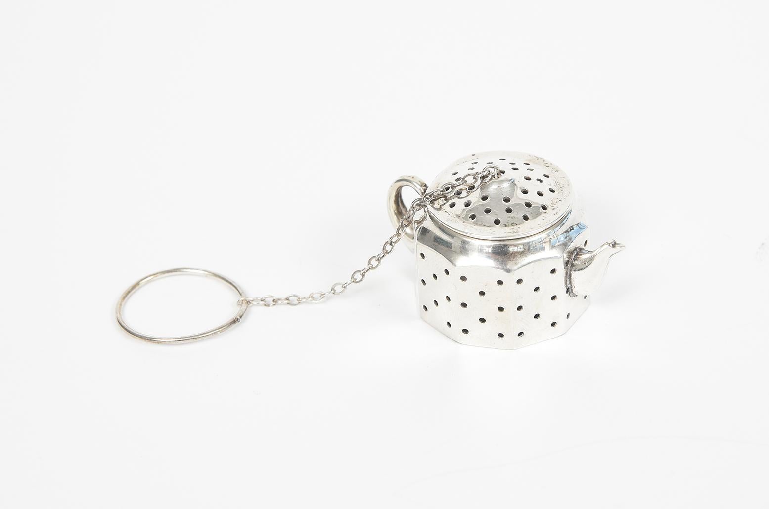 Vintage mid 20th century figural teapot sterling silver tea holder infuser with a hinged lid. It comes with its original chain Made by Amcraft Attleboro Mass which is a company that made sterling items for US military insignia items during WWI &