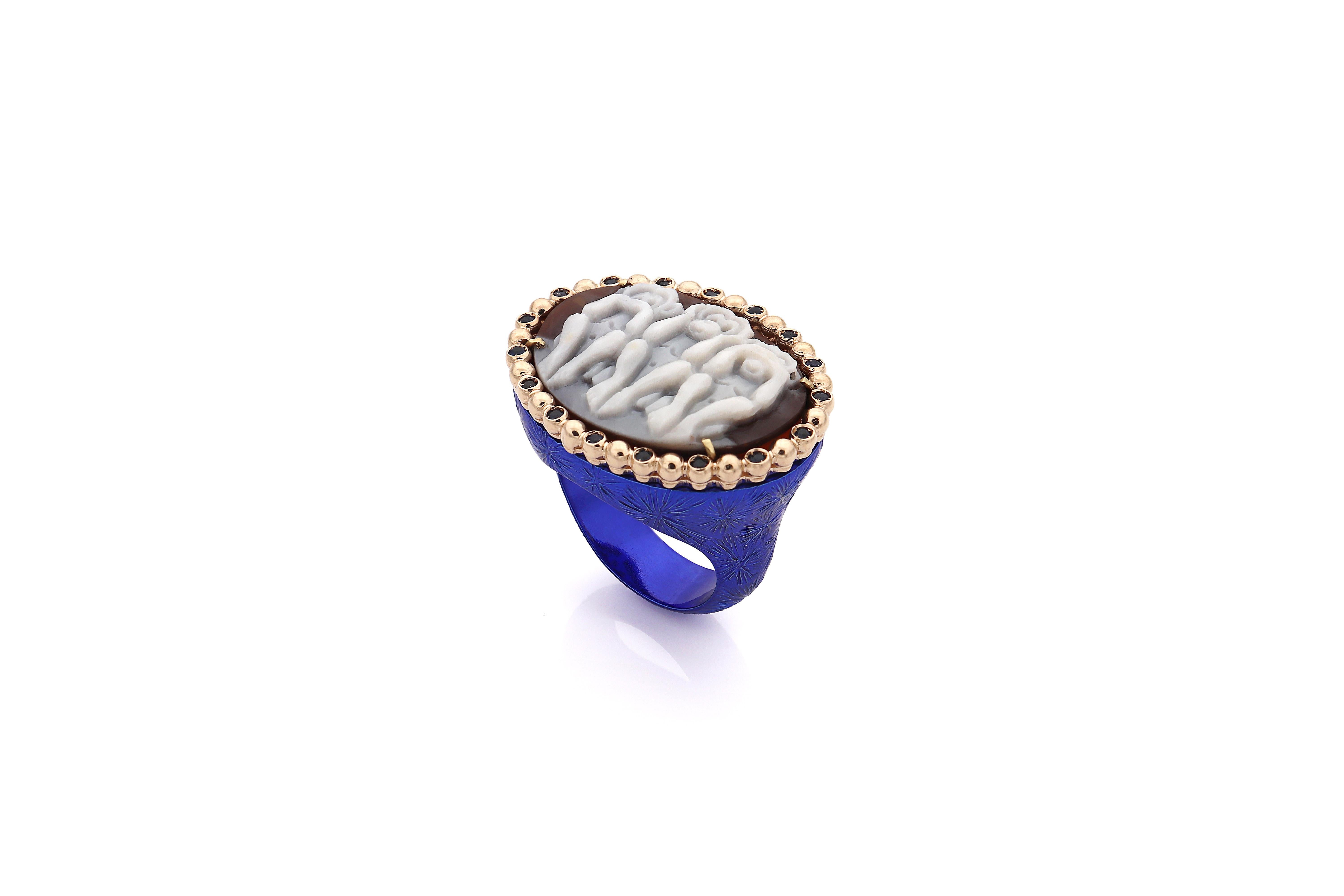 25mm sardonyx shell cameo hand-carved, on 9kt gold and sterling silver with ﻿0.20ct blue sapphires.

Comes in different colors, such as black and green, contact us for more details.