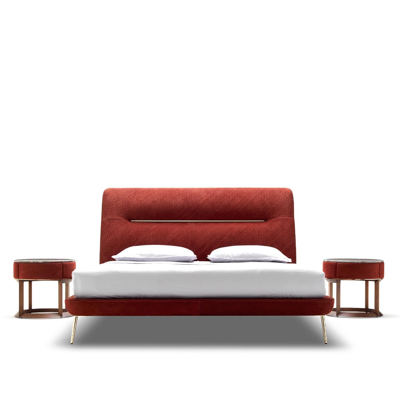 This bed is a one of a kind piece of the Vanity collection. Showcasing an elegant and refined design of timeless flair, its exquisite frame boasts a splendid burgundy Grassé leather upholstery, enriched with gold-finished metal details. Softly