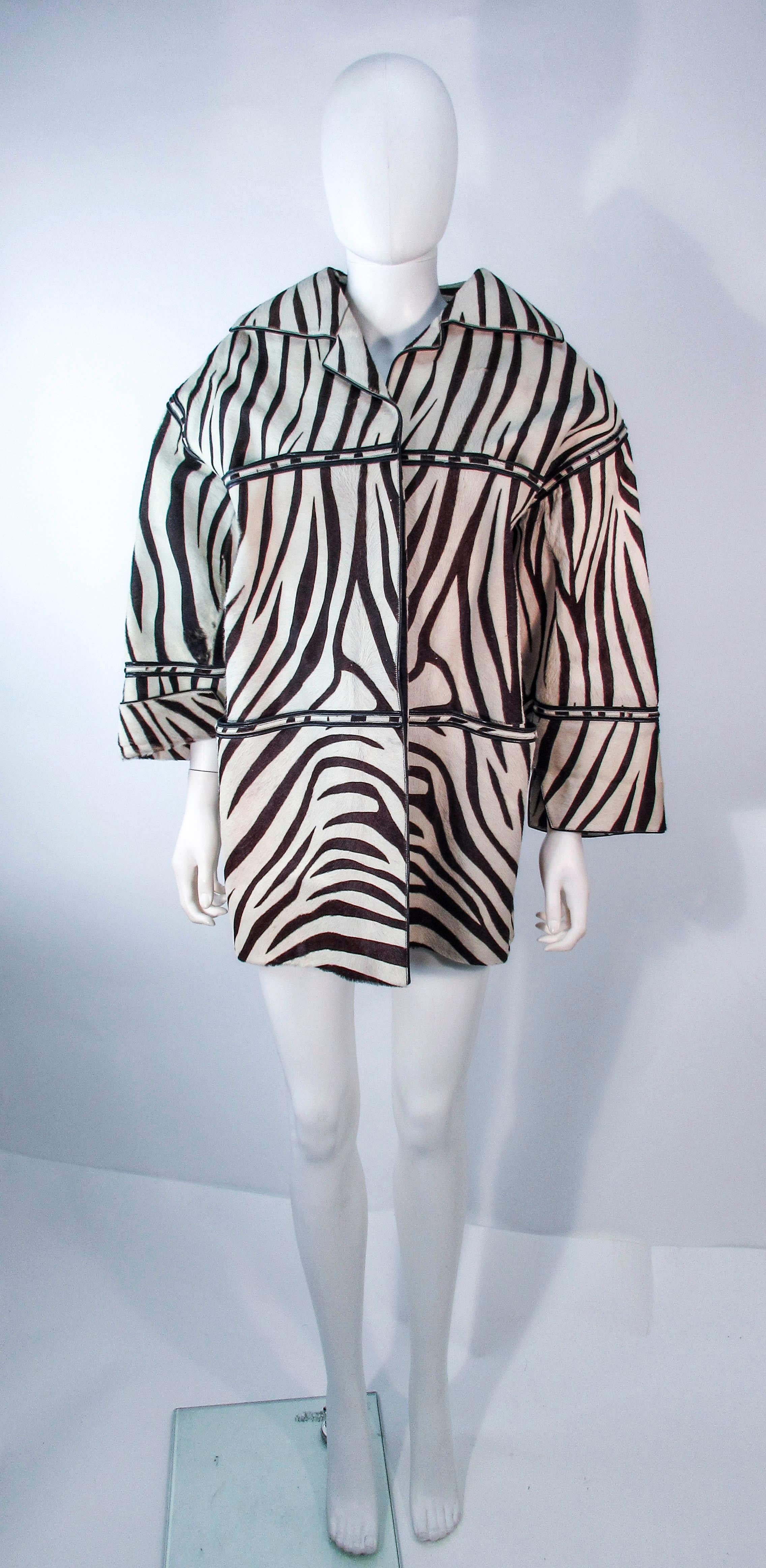 This wonderful coat is an Amen Wardy design. It is composed of a zebra pattern cowhide. Features four front pockets and center front button closures. In excellent vintage condition, some signs of wear due to age. Please feel free to ask us any