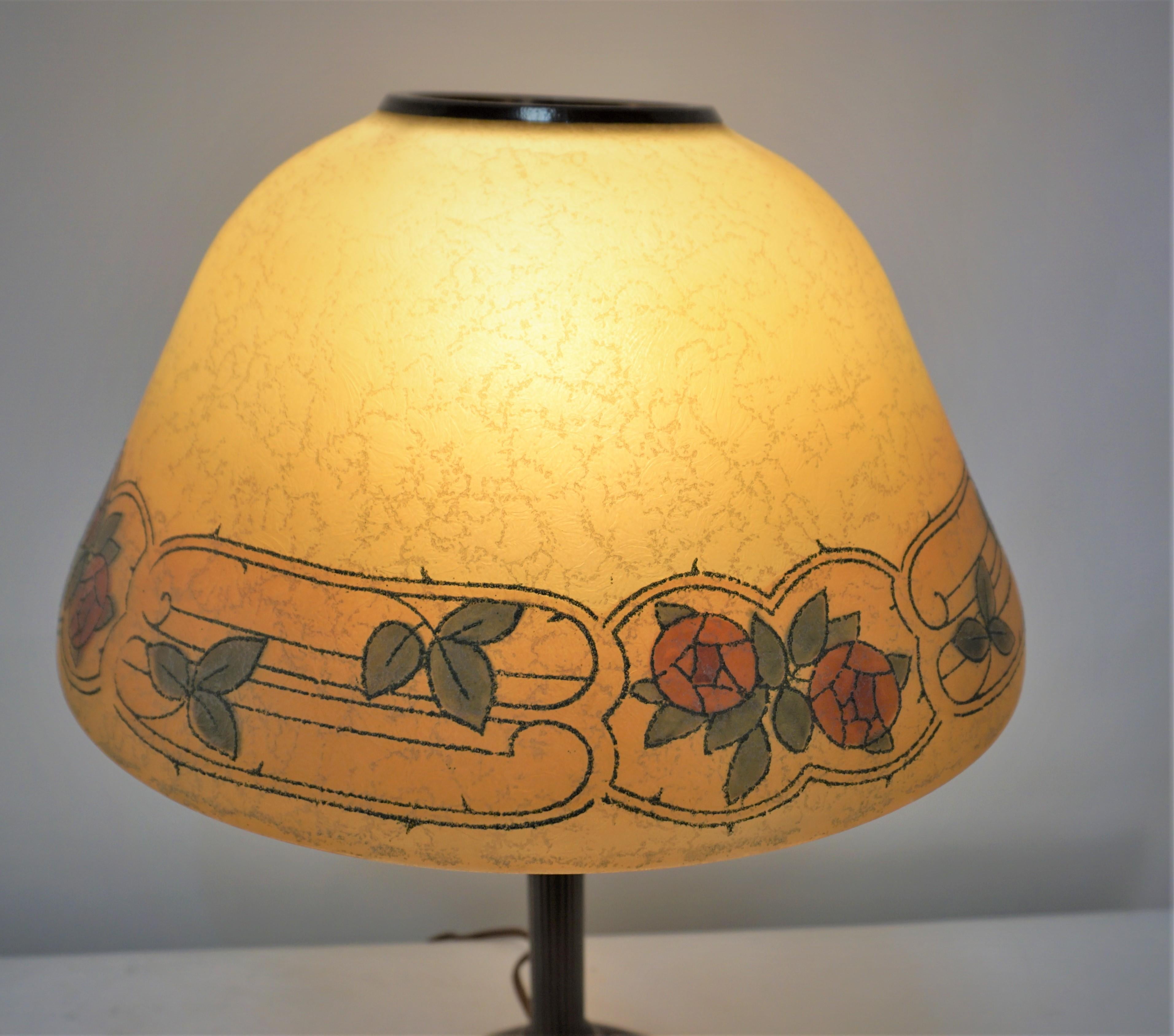 Beautiful American reverse painted glass shade and lacquered base table lamp by Handel.