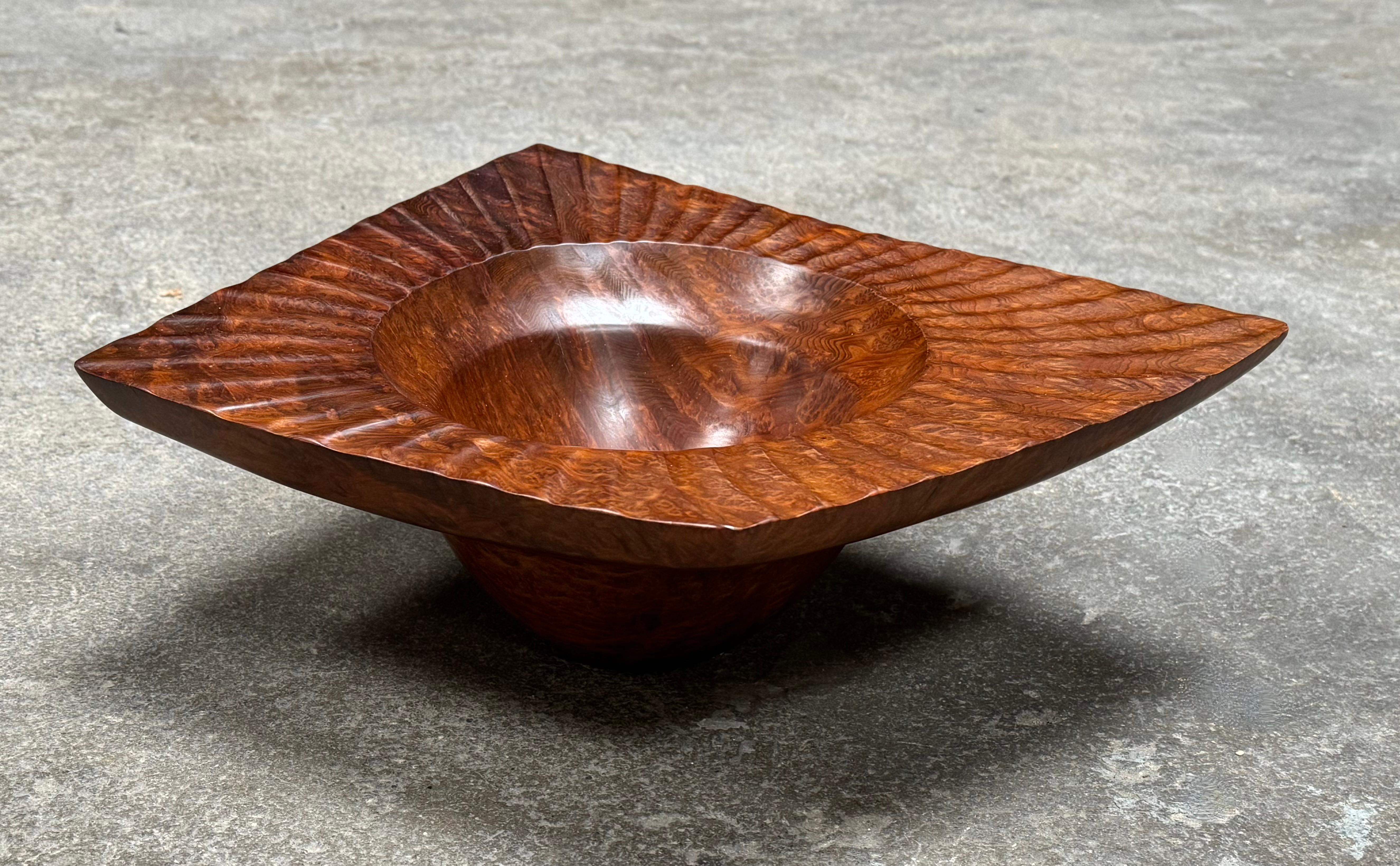 Hand turned and craved bowl by California craftsman Bruce Mitchell (1949-), created out of redwood burl and finished to a silky finish to the touch. With a rich color and organic form this is an outstanding example by this Pt. Reyes artist. Mitchell
