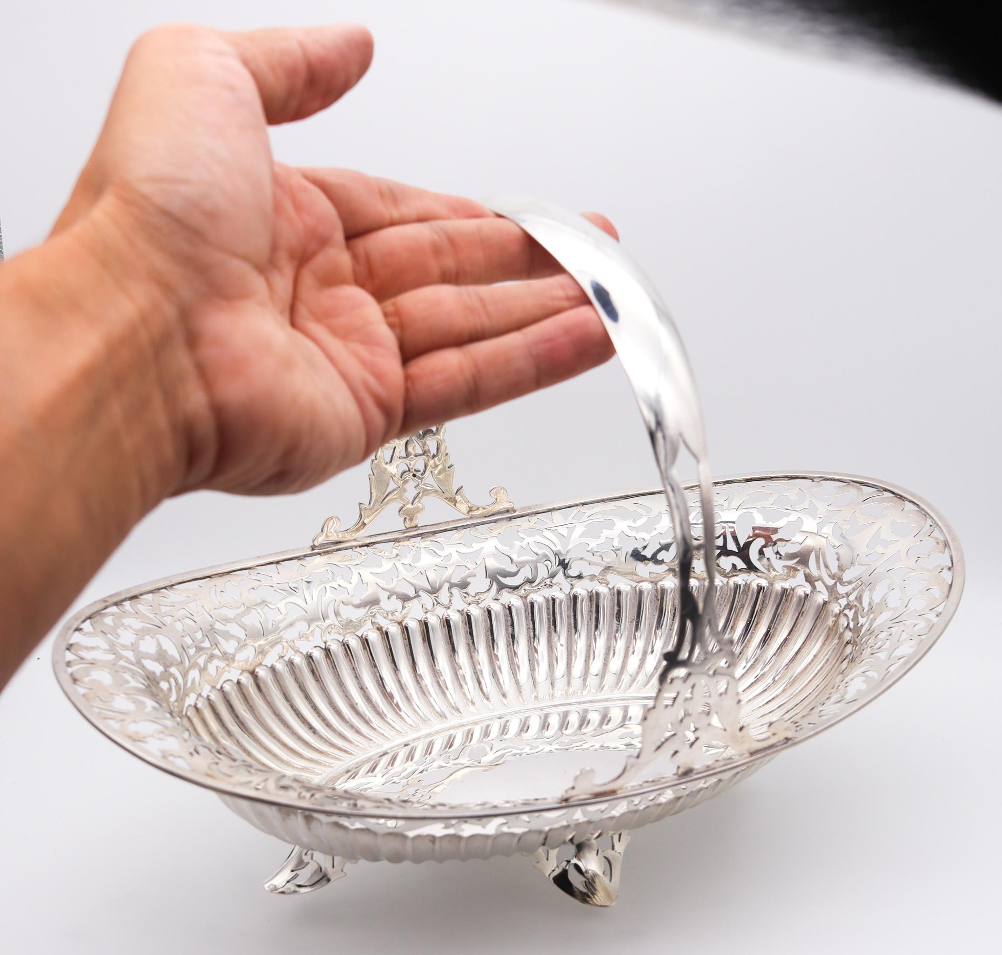 Sterling silver navette basket with handle.

Elegant sweetmeat basket tray with a fixed handle, crafted with an oval navette shape in solid .925/.999 sterling silver, back in the 1920's. This tray is decorated with fluted scalloped patterns and